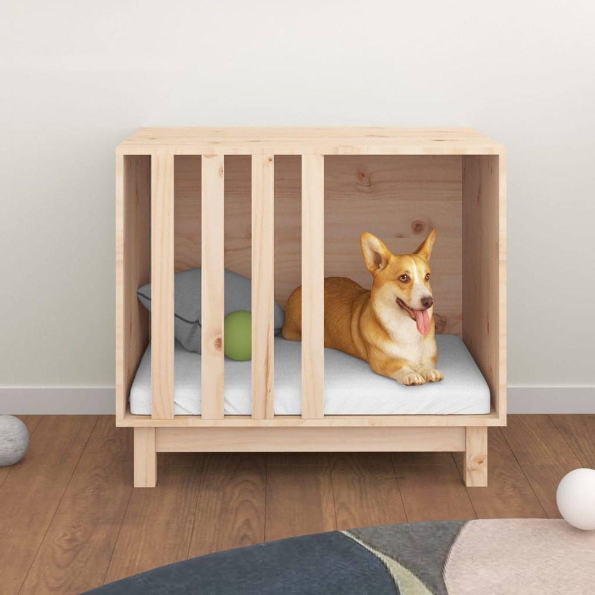 Ein Corgi liegt in einem Holzkäfig mit Kissen und Ball.