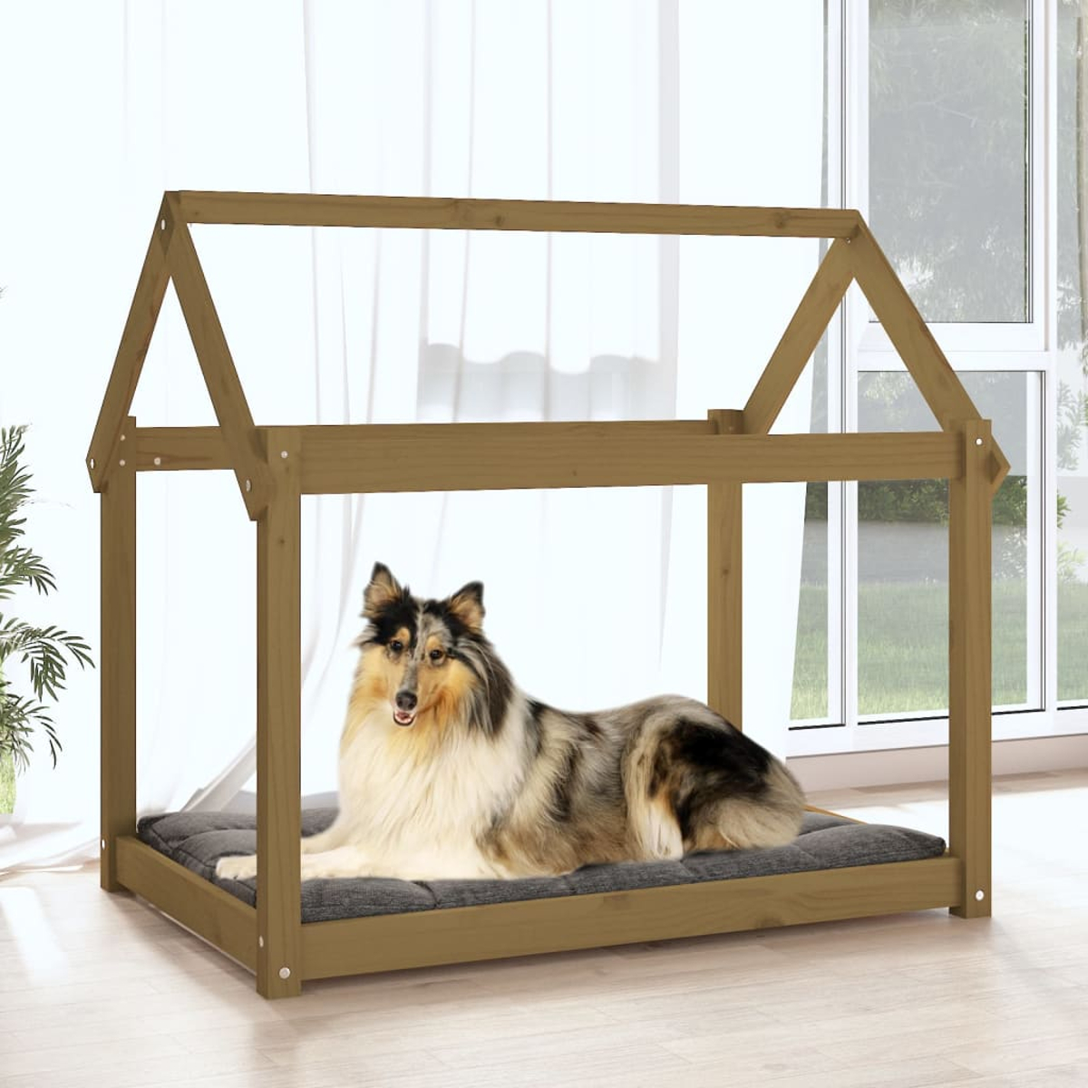 Ein Collie liegt auf einem Kissen in einem Holzhundehaus vor einem Fenster.