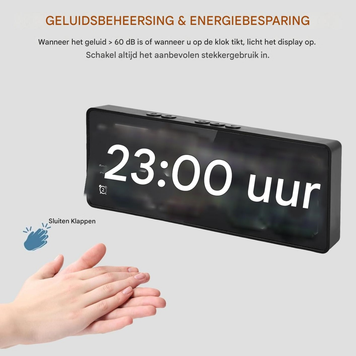 Ein digitaler Wecker zeigt 23:00 Uhr an. Hände klatschen in der Nähe.