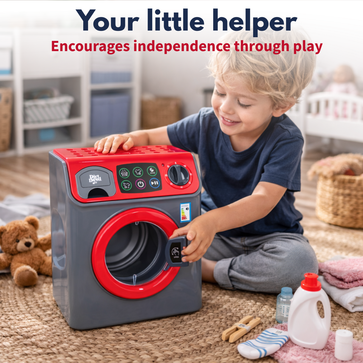 A boy plays with a toy washing machine, laundry, and cleaning supplies.
