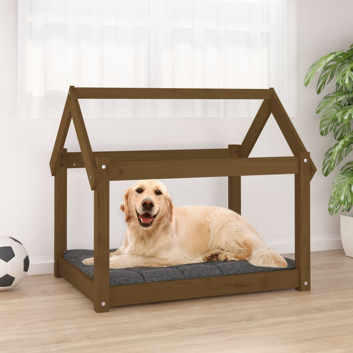 Ein goldener Retriever liegt auf einem dunklen Kissen in einem braunen Hundebett im Hausdesign.