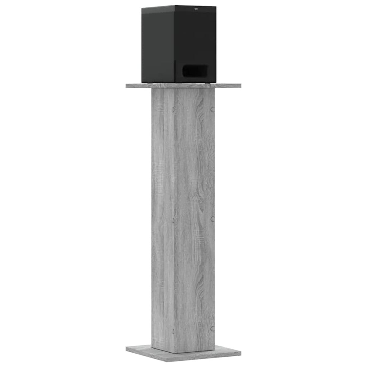 Ein schwarzer Subwoofer steht auf einem Holzsockel in Holzoptik.
