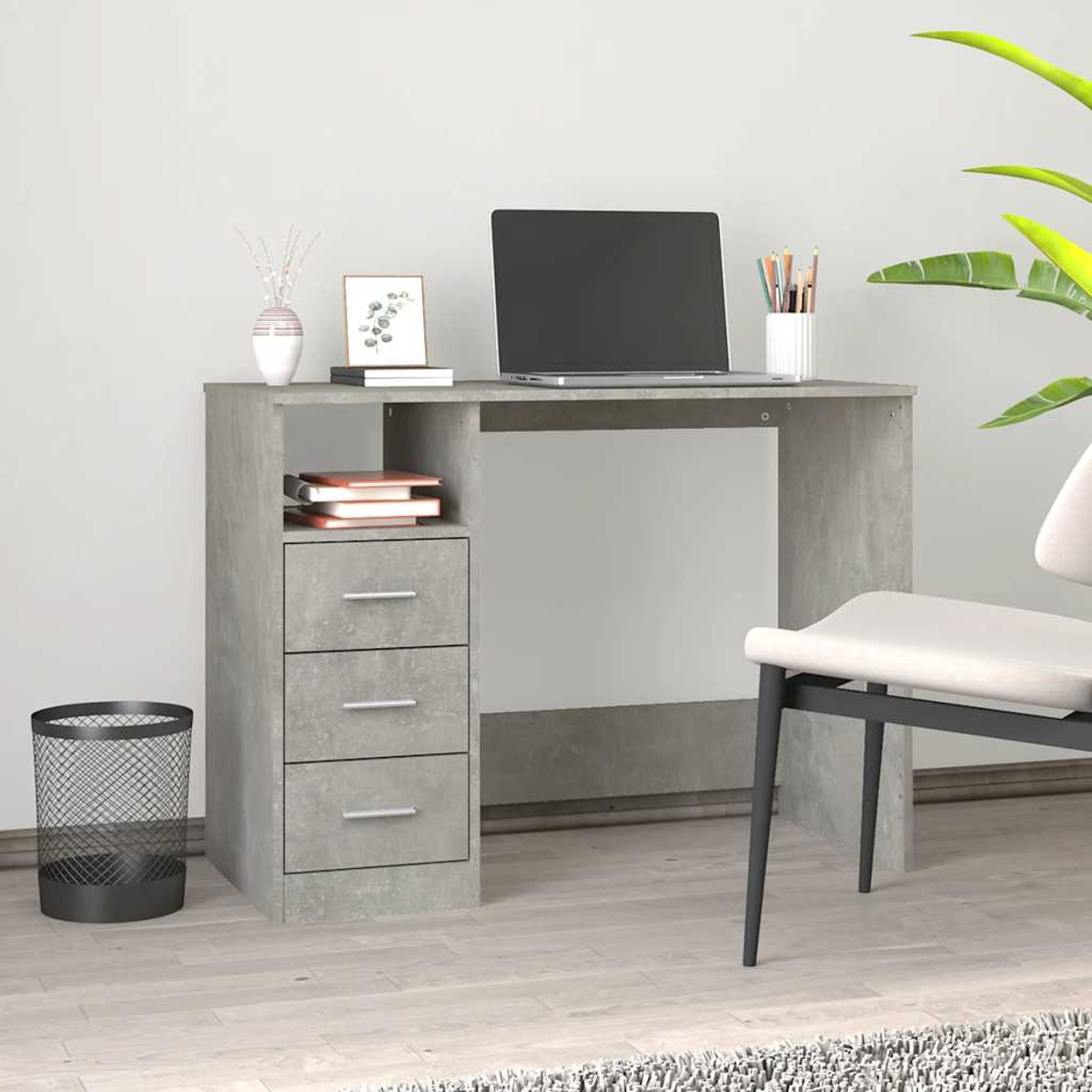 Grauer Schreibtisch mit Laptop, Büchern, einem Korb und einem Stuhl.