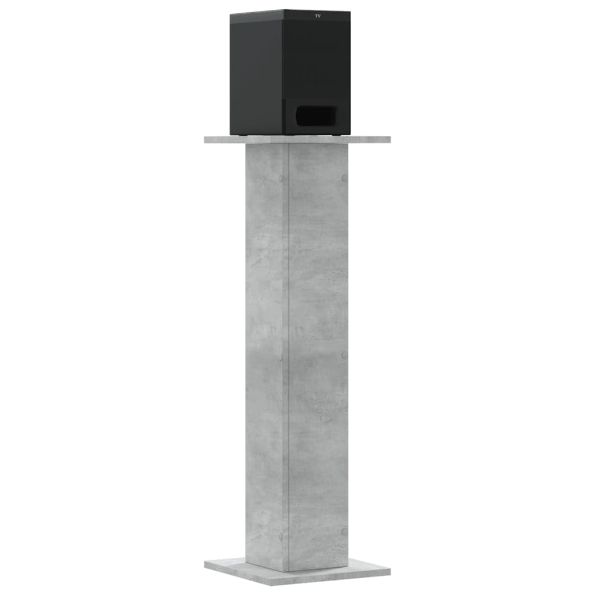 Ein schwarzer Subwoofer steht auf einem grauen Steinsockel.