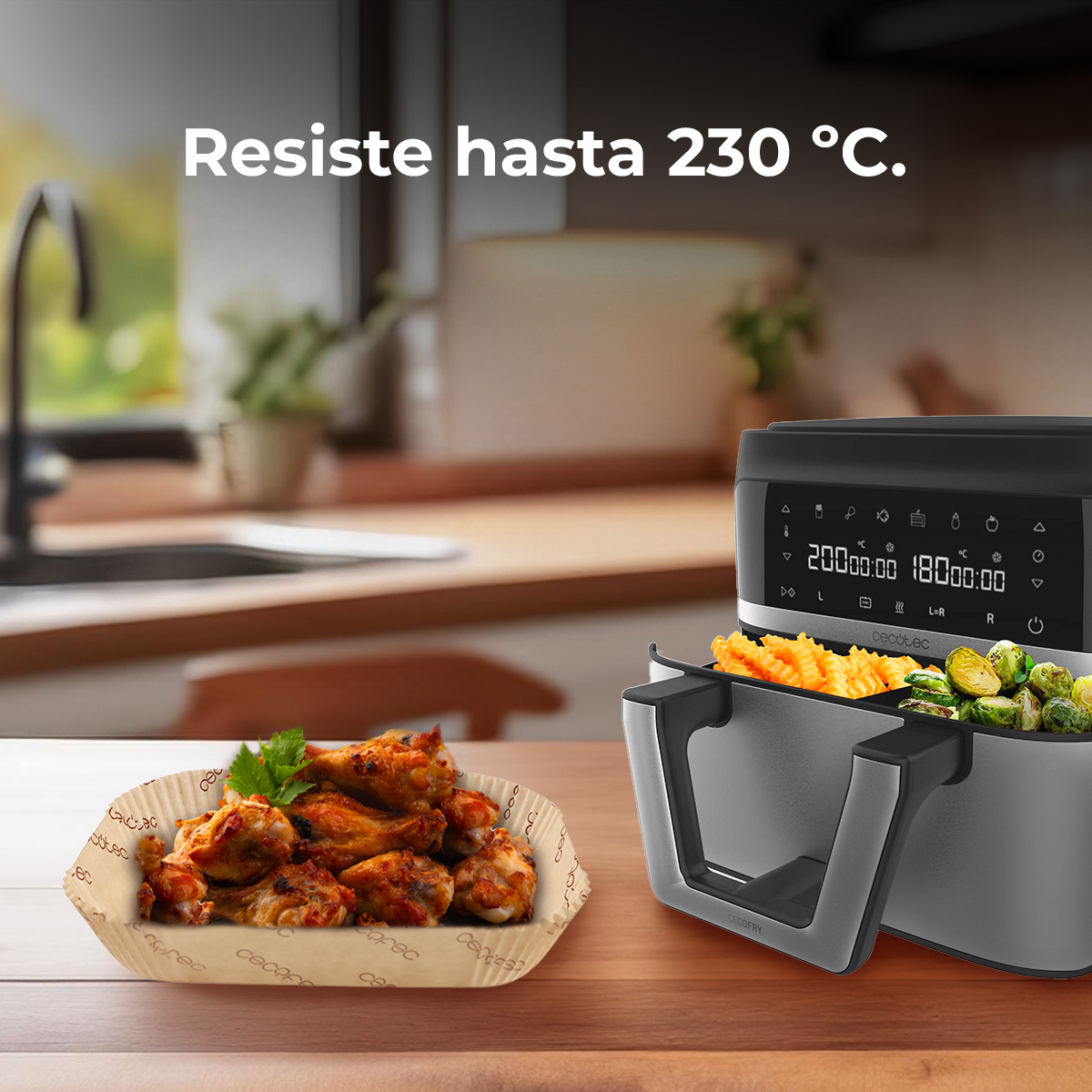 Un air fryer con alitas de pollo, papas fritas y coles de Bruselas. Hasta 230°C.