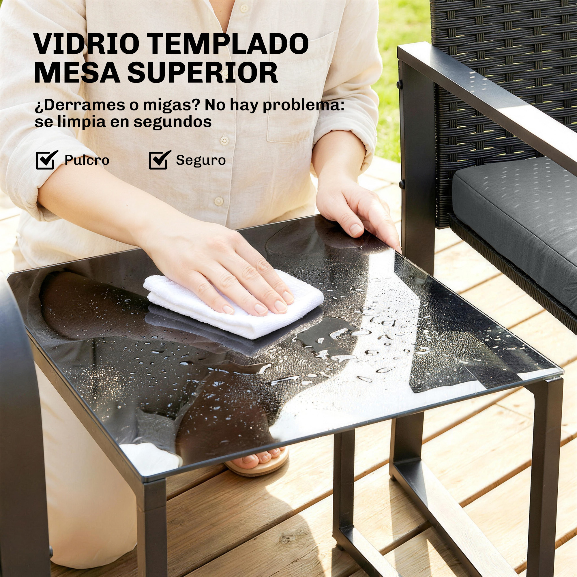 Una persona limpia una mesa de cristal negra brillante con un paño blanco.