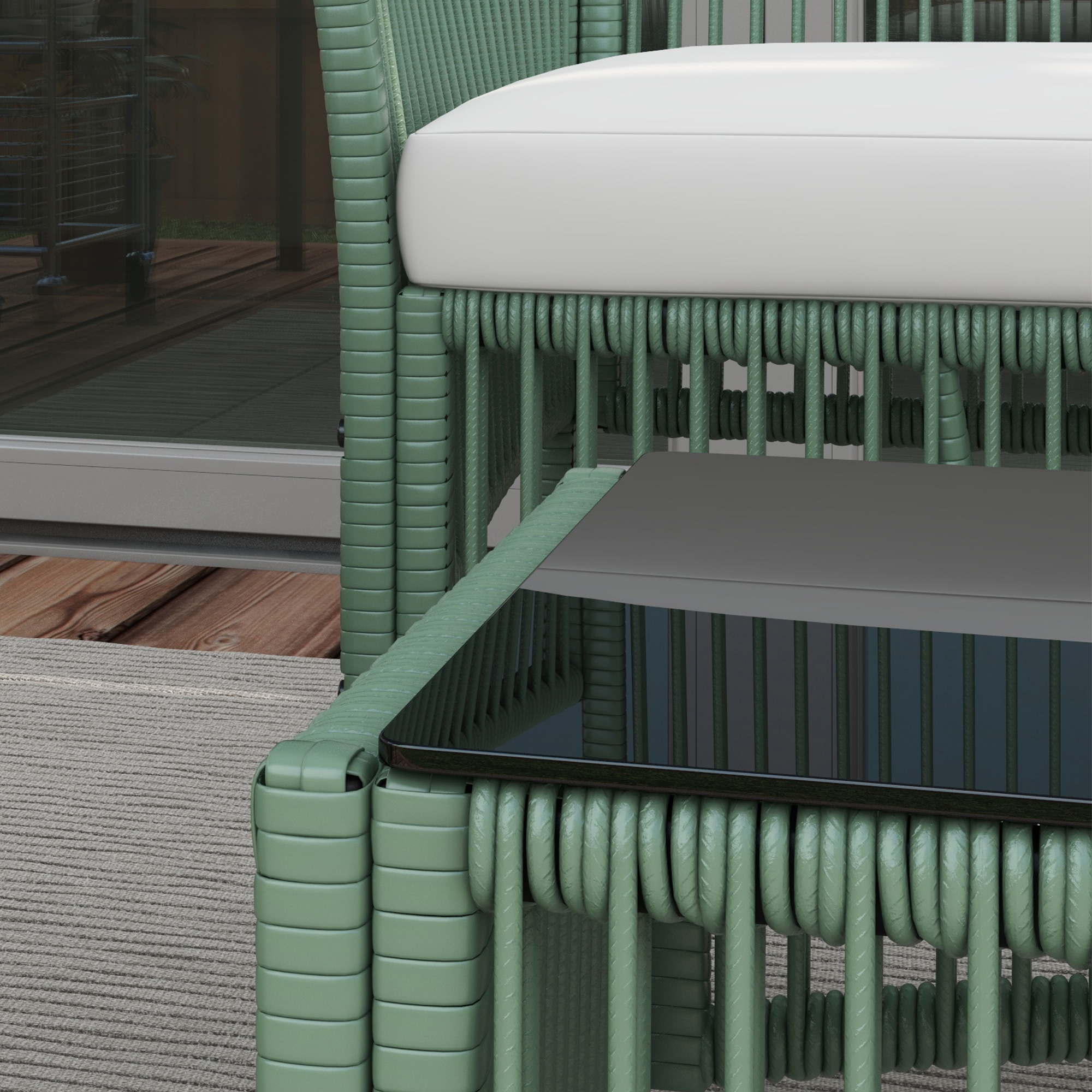 Mobili in rattan verde con cuscino bianco e piano nero su tappeto.