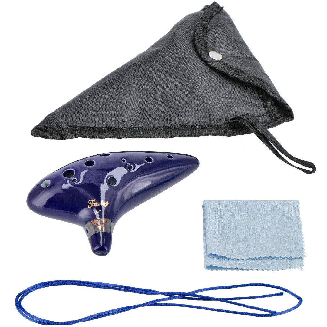 A dark blue ocarina with a carrying bag, cleaning cloth, and blue string.
