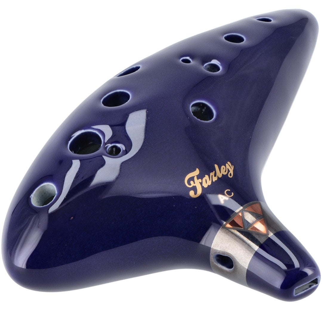 A dark blue ocarina with gold lettering and silver accents.