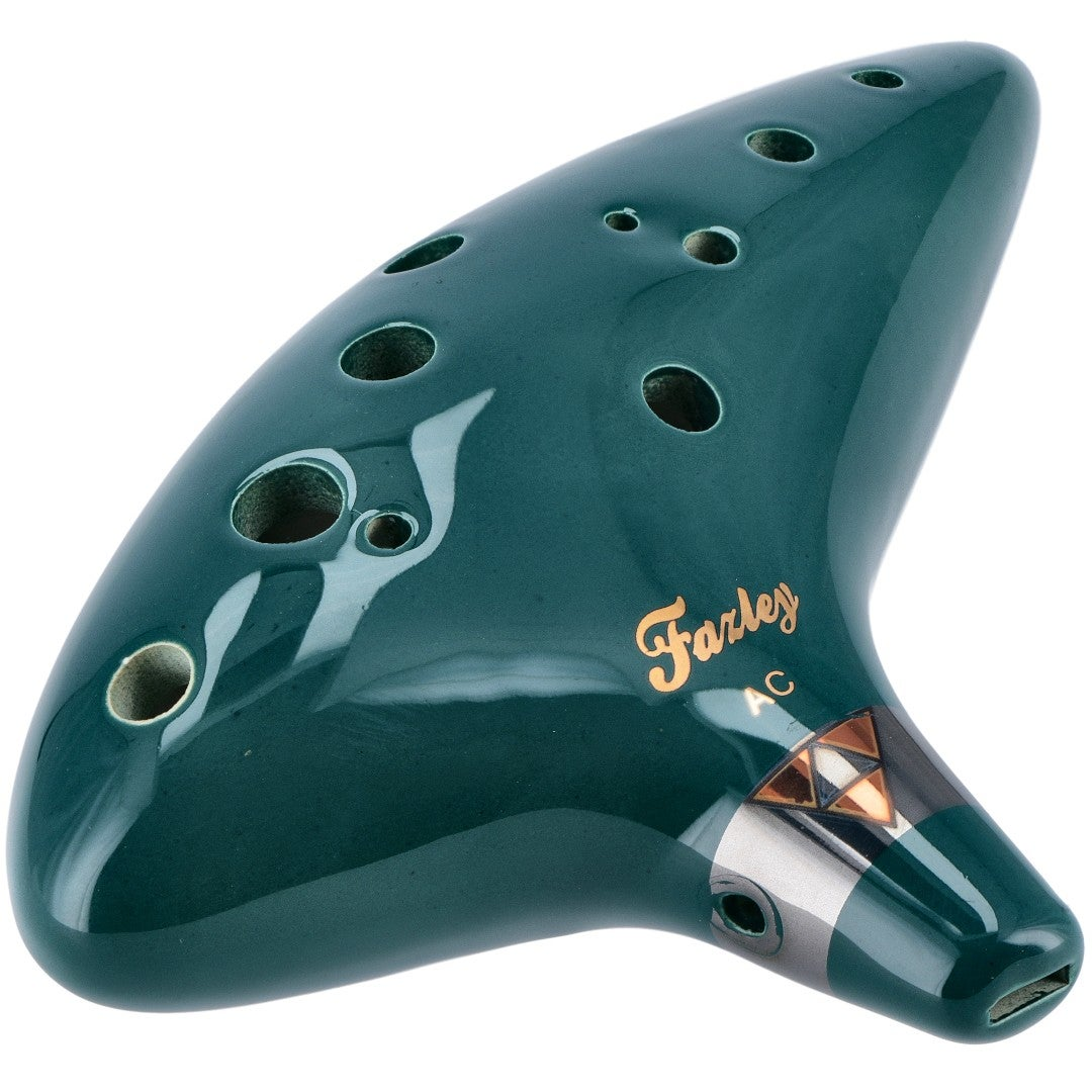 Dark green ocarina with many holes and golden lettering.