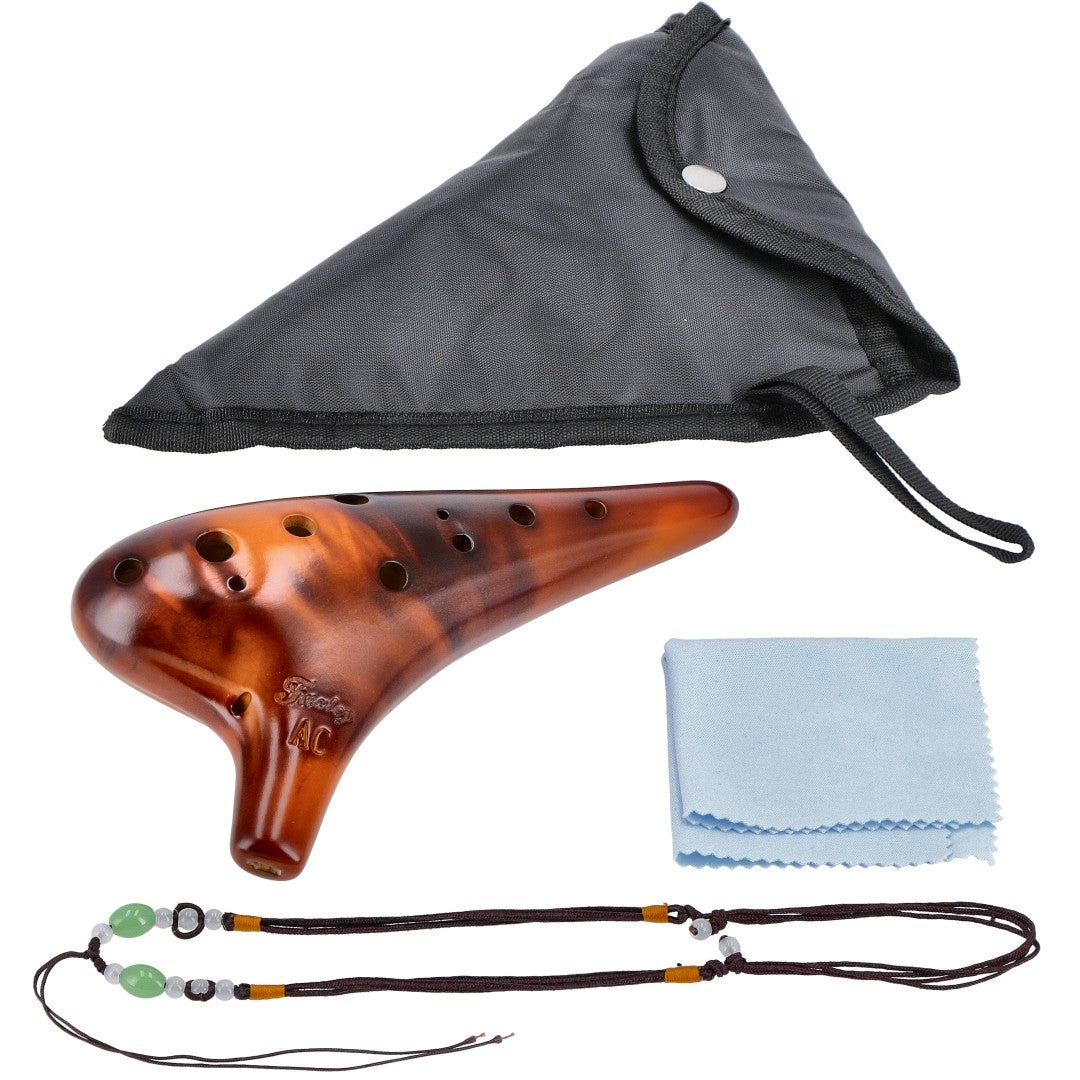 A brown ocarina instrument with accessories: bag, cloth, and cord.