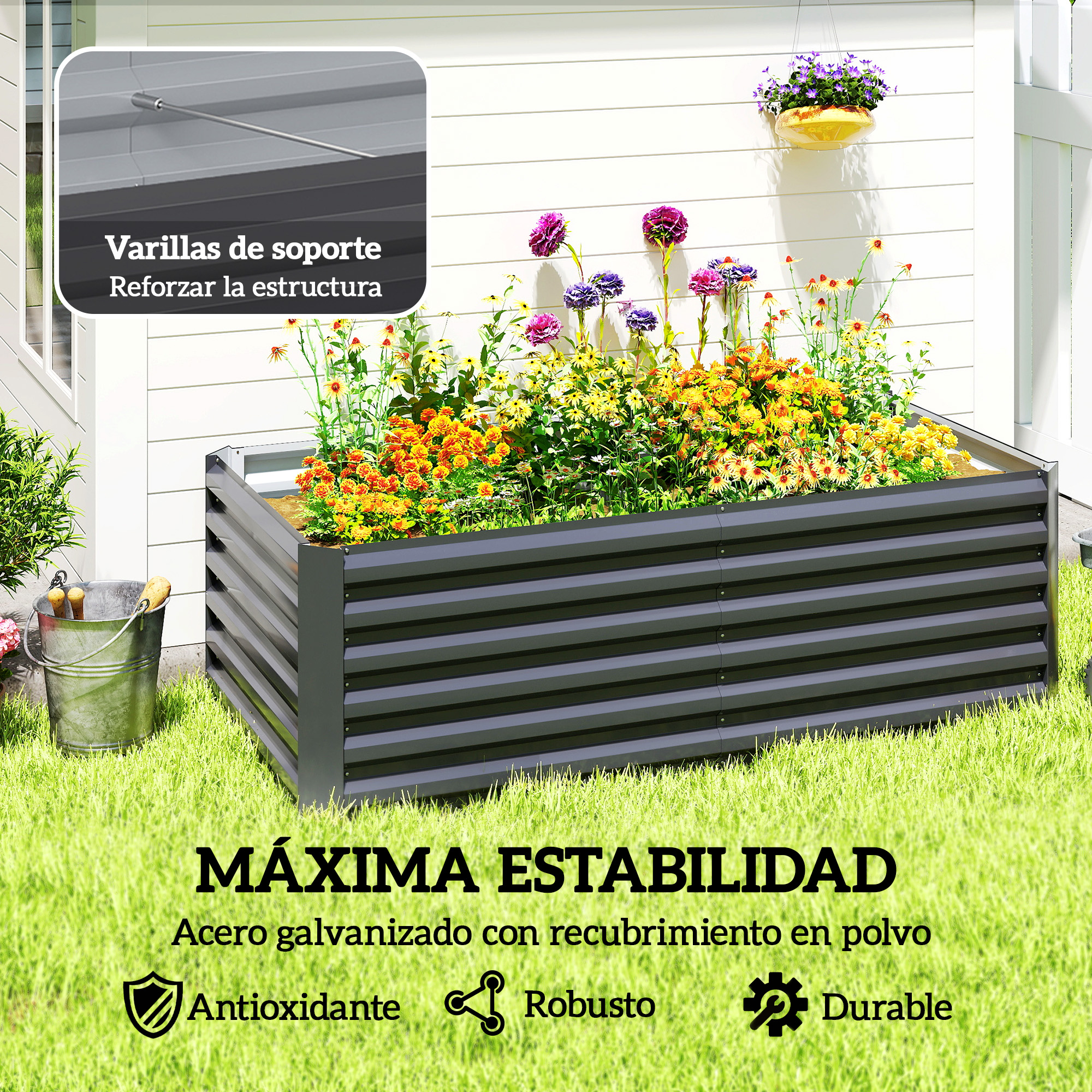 Un bancal elevado negro con flores y un cubo de metal al lado.