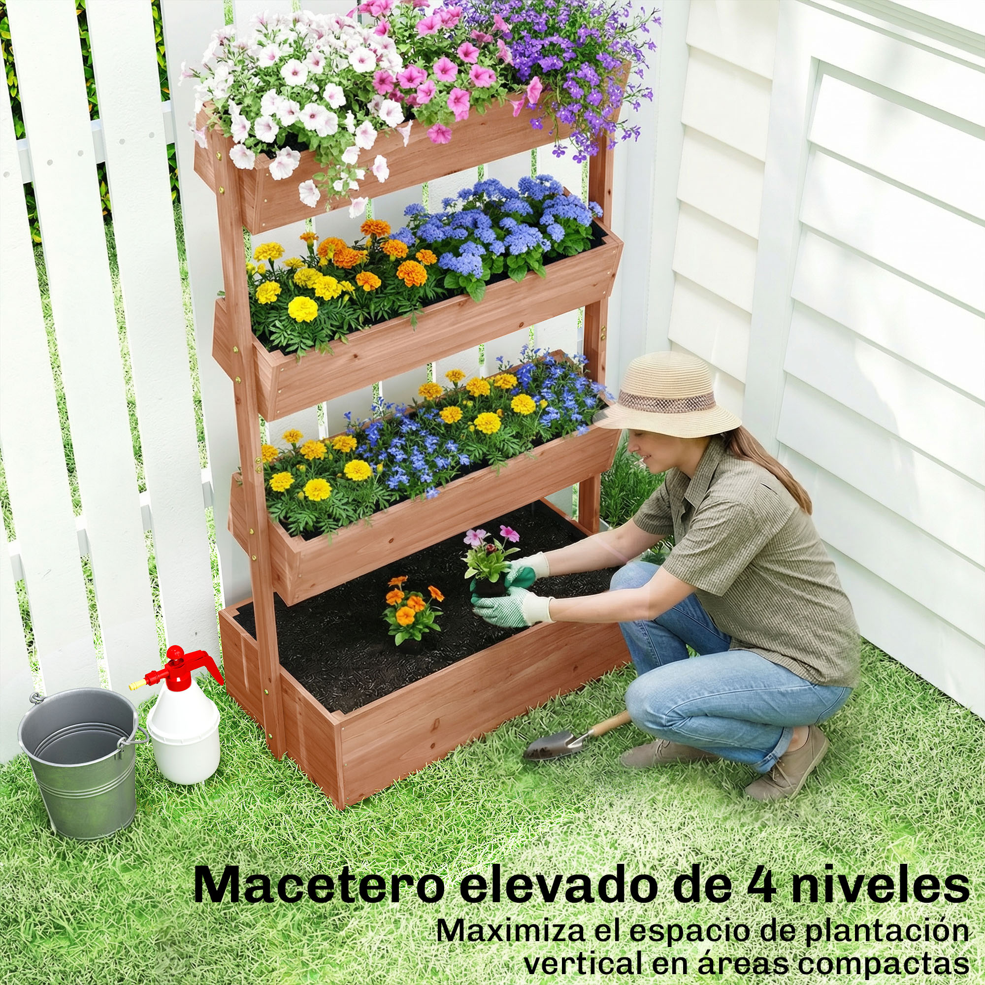 Una mujer planta flores en un macetero de madera de cuatro niveles junto a una valla.