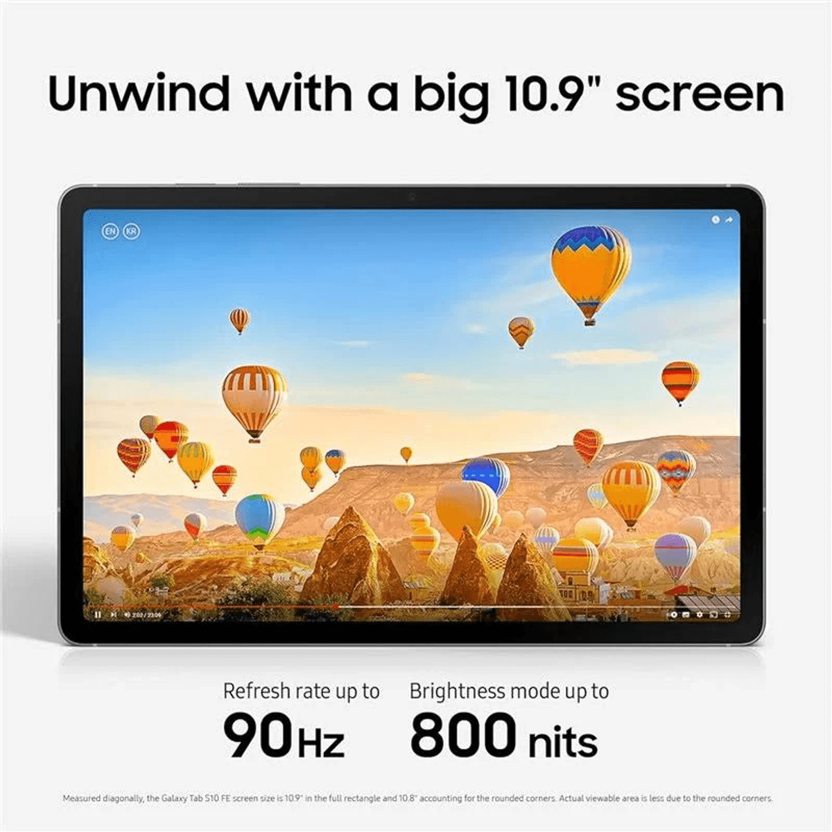 Tablet wyświetla niebo pełne kolorowych balonów na ogrzane powietrze nad skalistymi krajobrazami.
