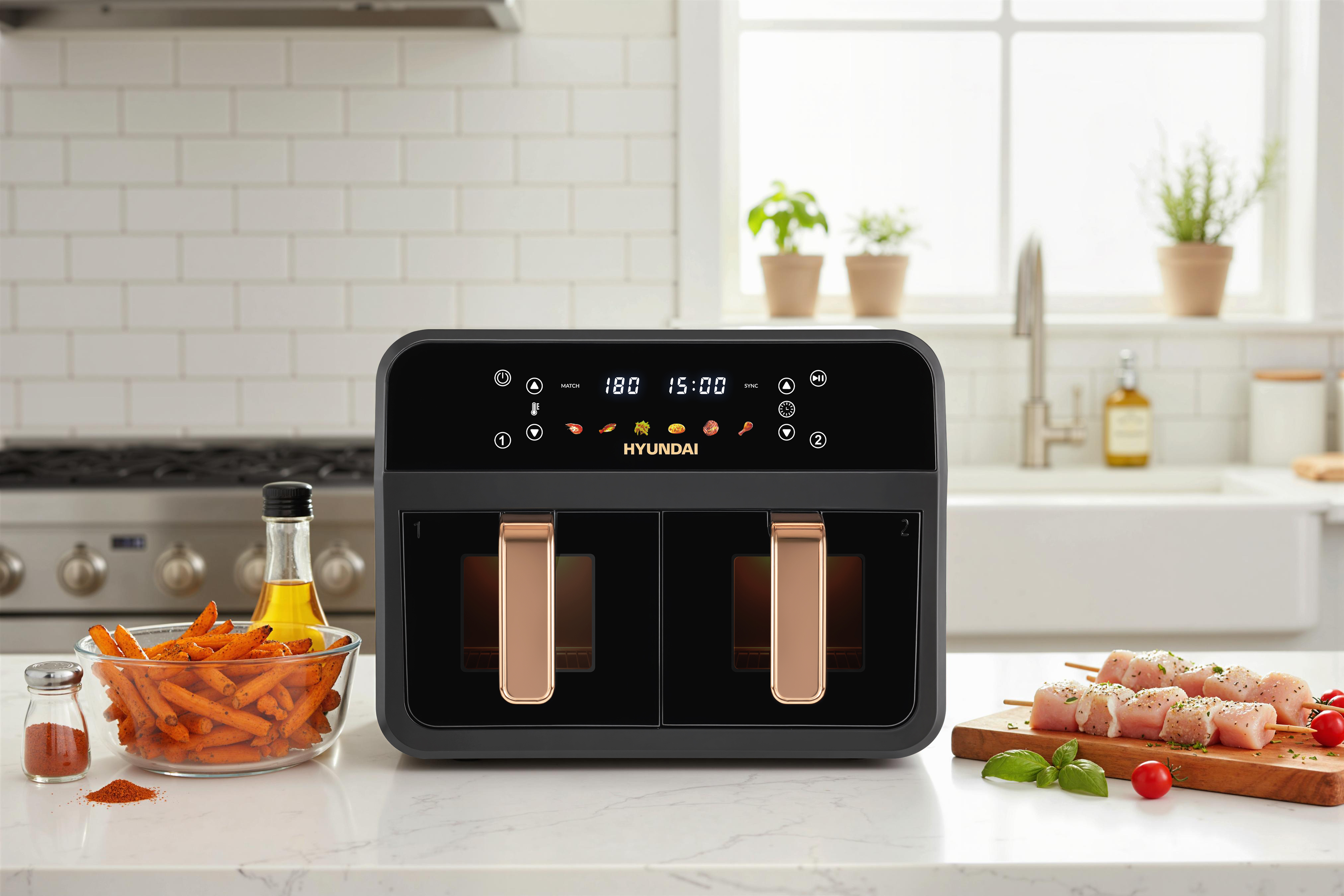 A black double air fryer with touchscreen, beside it a bowl of fries, oil, and skewers with chicken.