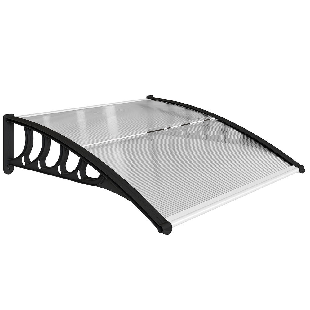 Un toldo transparente de policarbonato con soportes decorativos negros está montado en una pared blanca.