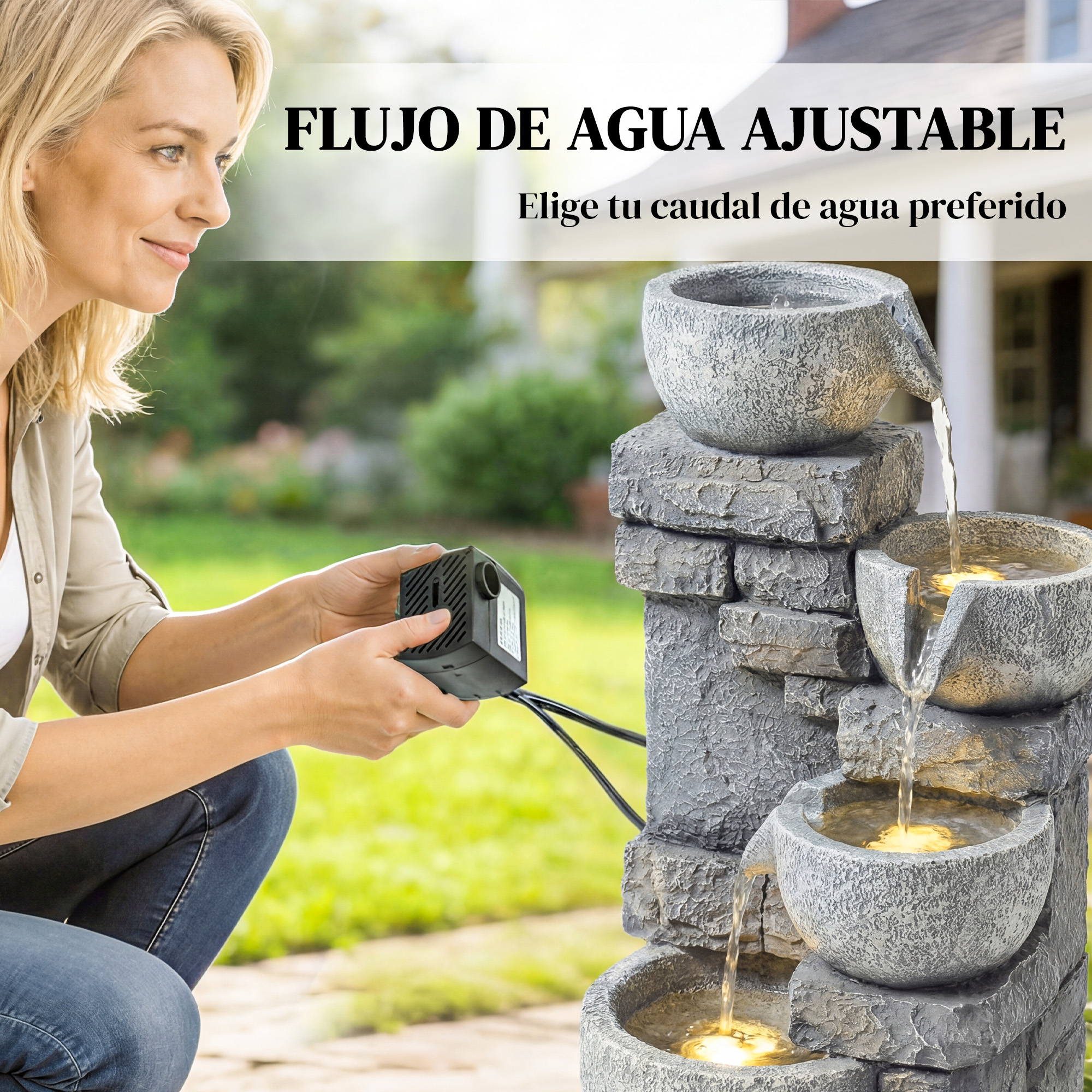 Mujer sostiene una pequeña bomba de agua negra junto a una fuente de agua escalonada.