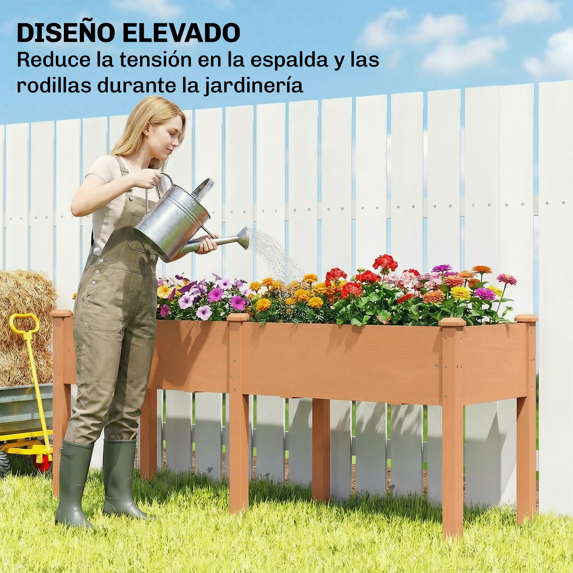 Mujer regando flores en un bancal elevado, carretilla de heno y pala amarilla detrás.
