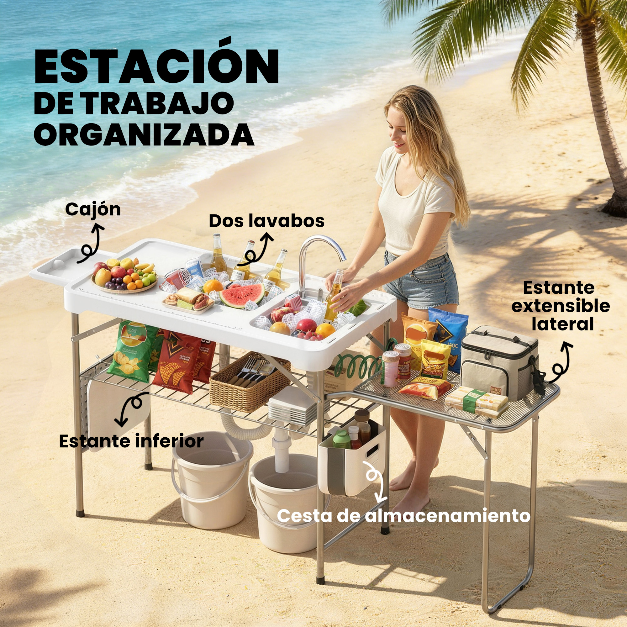 Estación de trabajo organizada en la playa con fregadero, frutas y bebidas.
