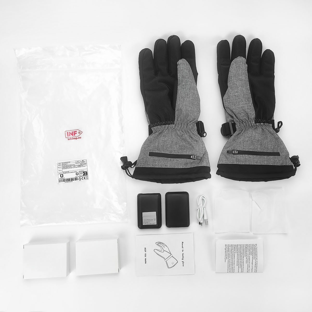 Un paio di guanti riscaldati grigi e neri con accessori su sfondo bianco.
