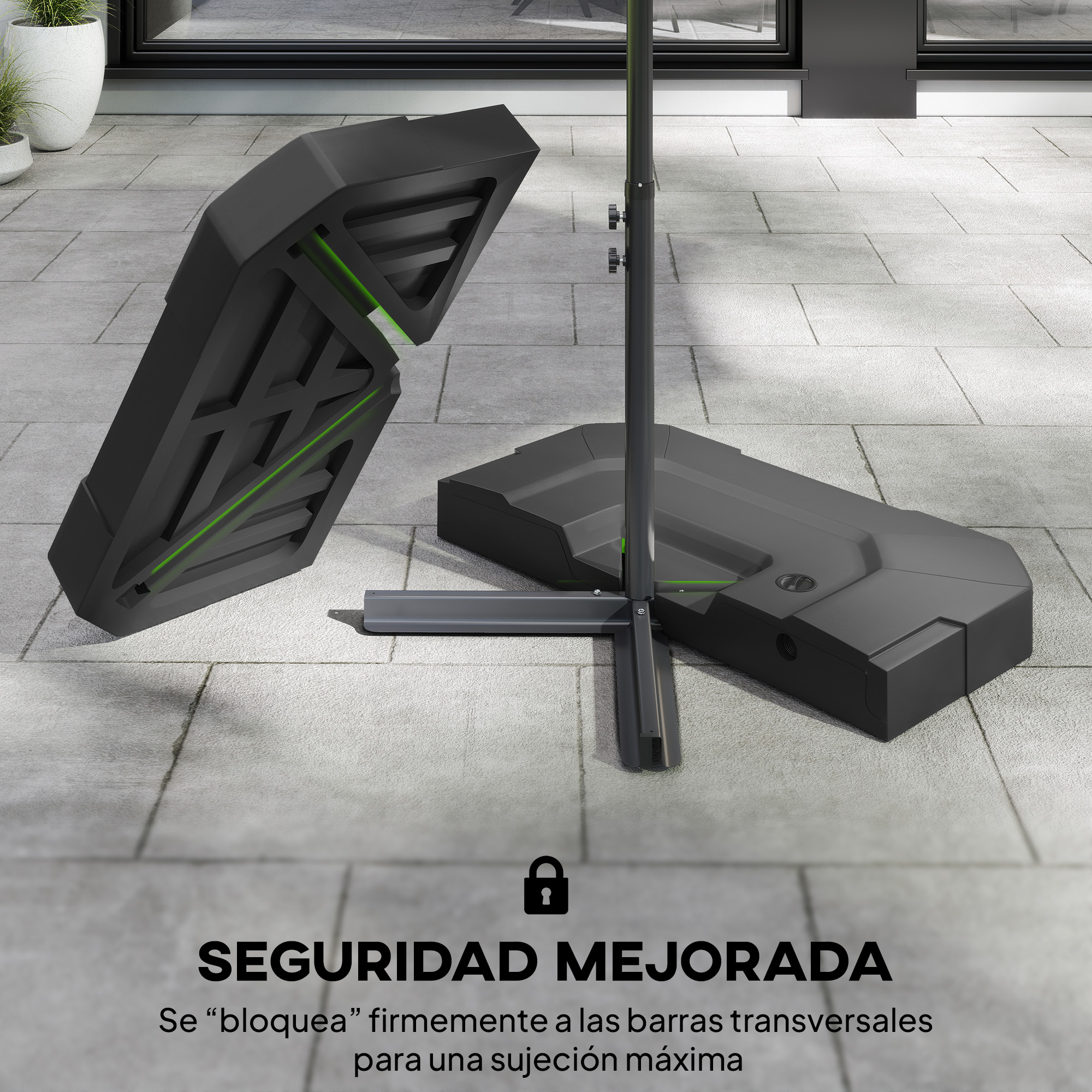 Bases negras para sombrilla con acentos verdes sobre superficie pavimentada.