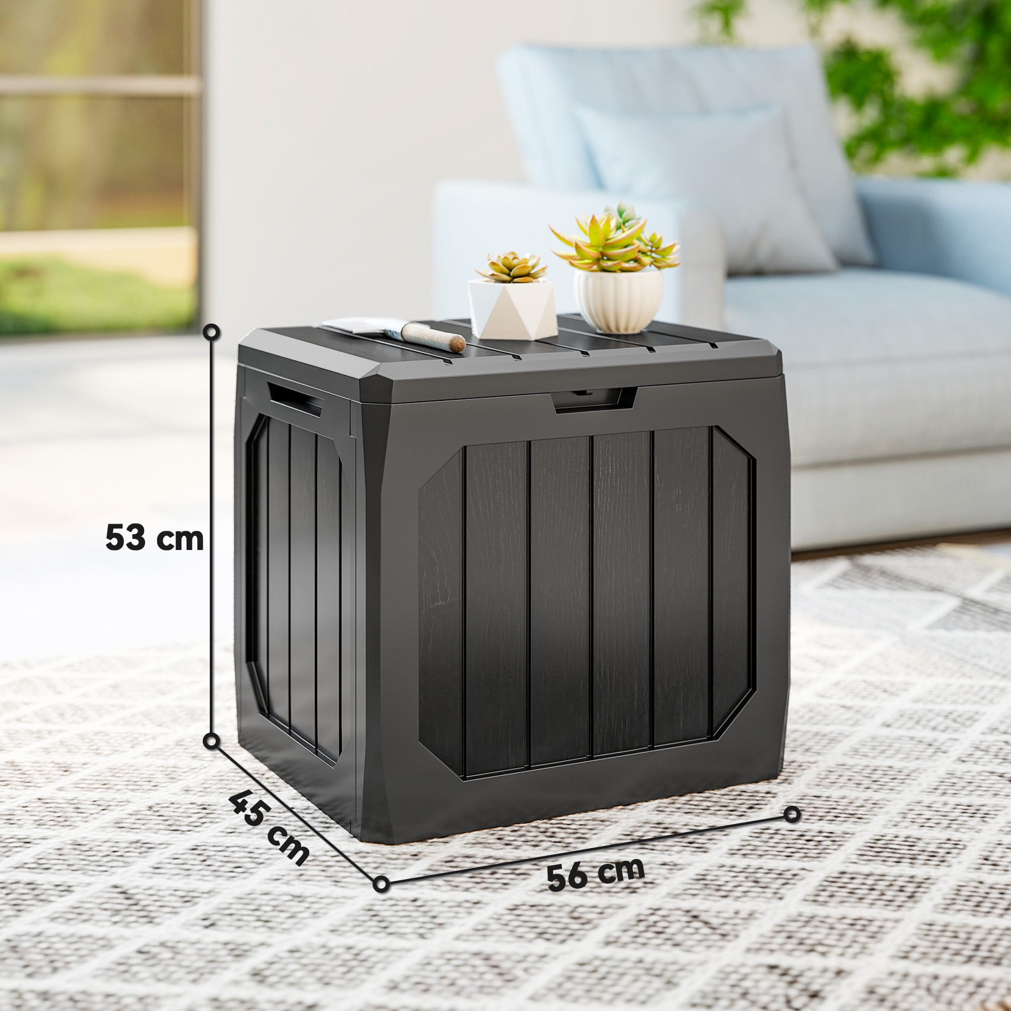 Caja de almacenamiento negra, 56x45x53cm, sobre alfombra, con plantas.