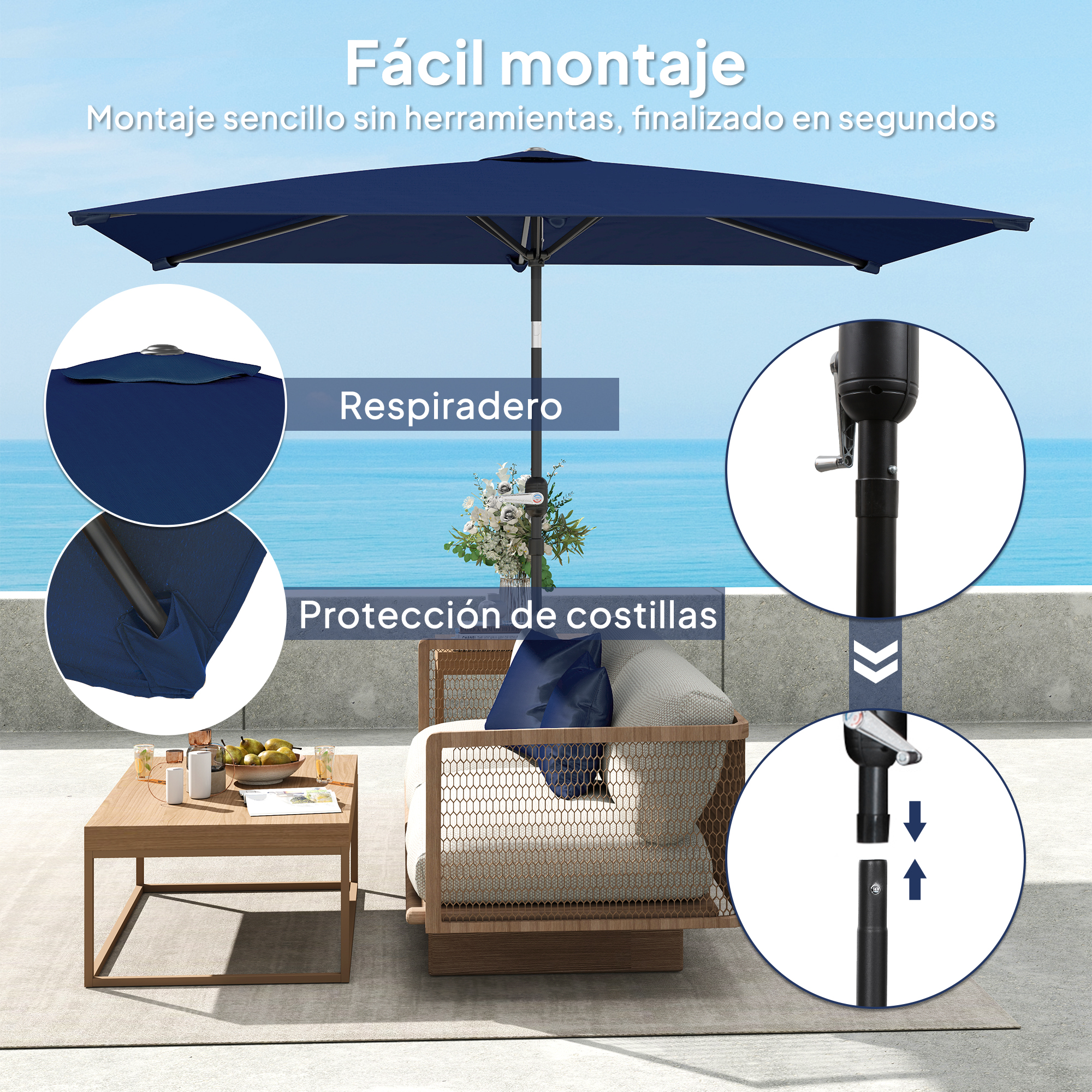 Un paraguas azul oscuro con mesa y sillas en un patio junto al mar.