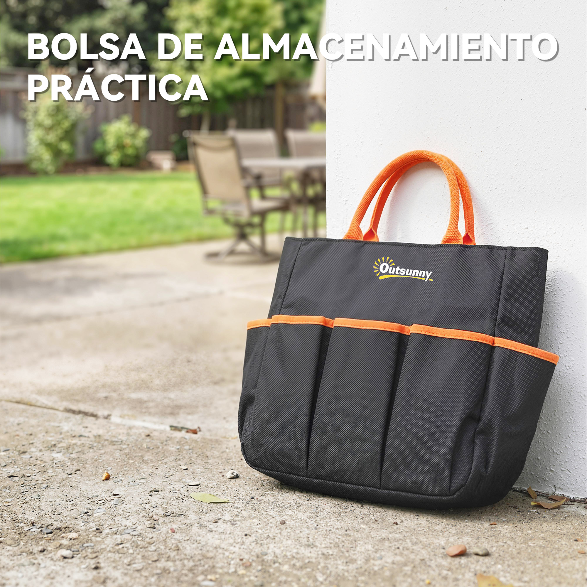 Bolsa negra con asas y bolsillos naranjas descansa sobre un camino de concreto.