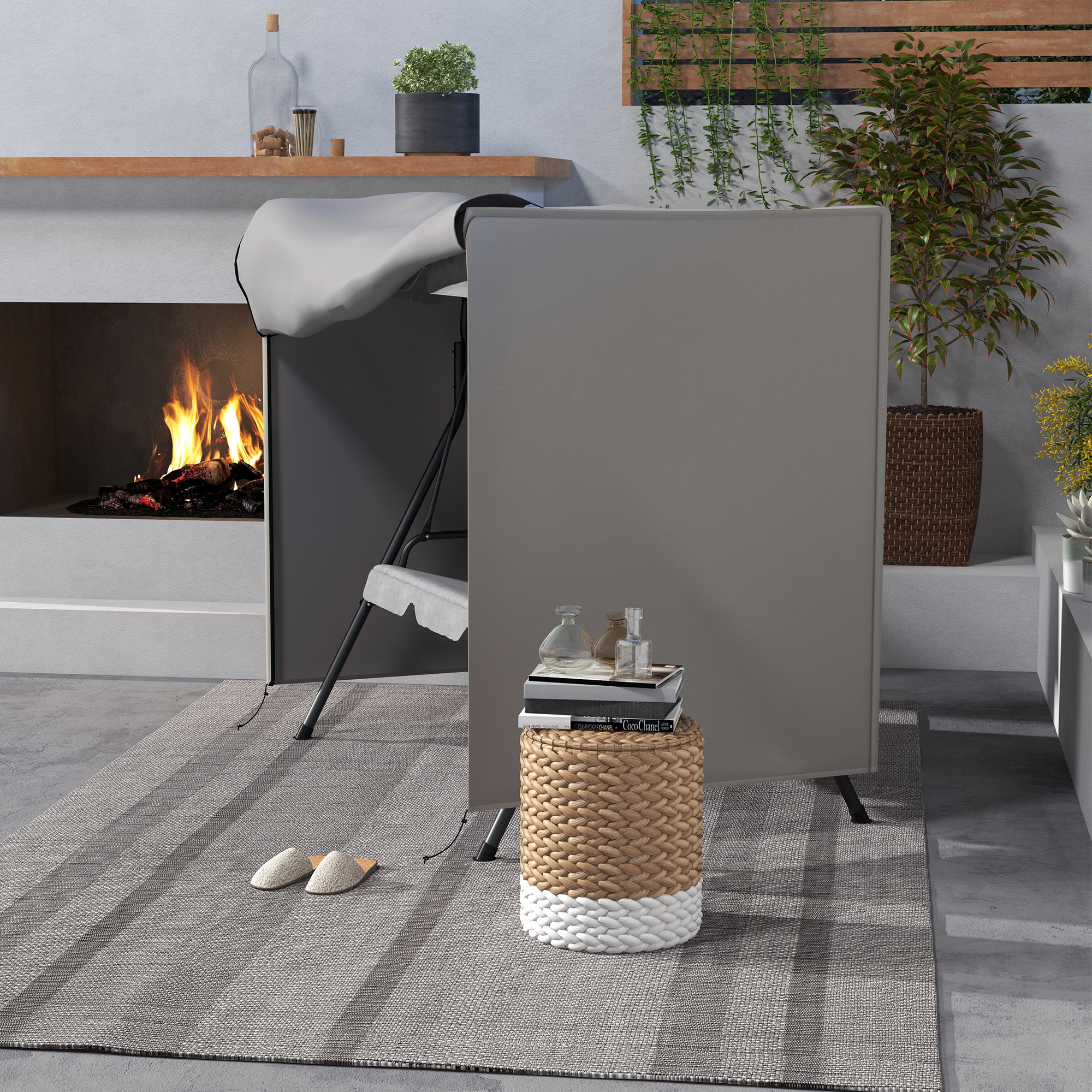 Una chimenea arde, una silla y una cesta con libros están sobre una alfombra.