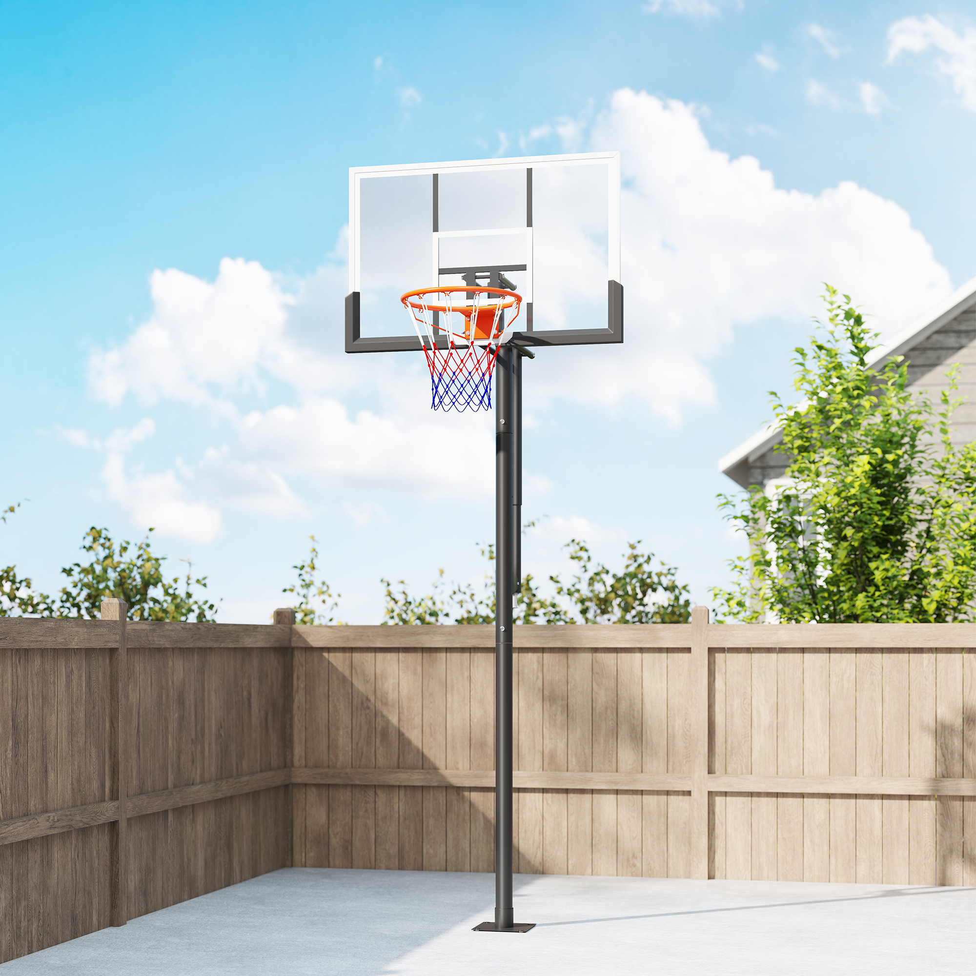 Una canasta de baloncesto se alza en una cancha de hormigón junto a una valla de madera.