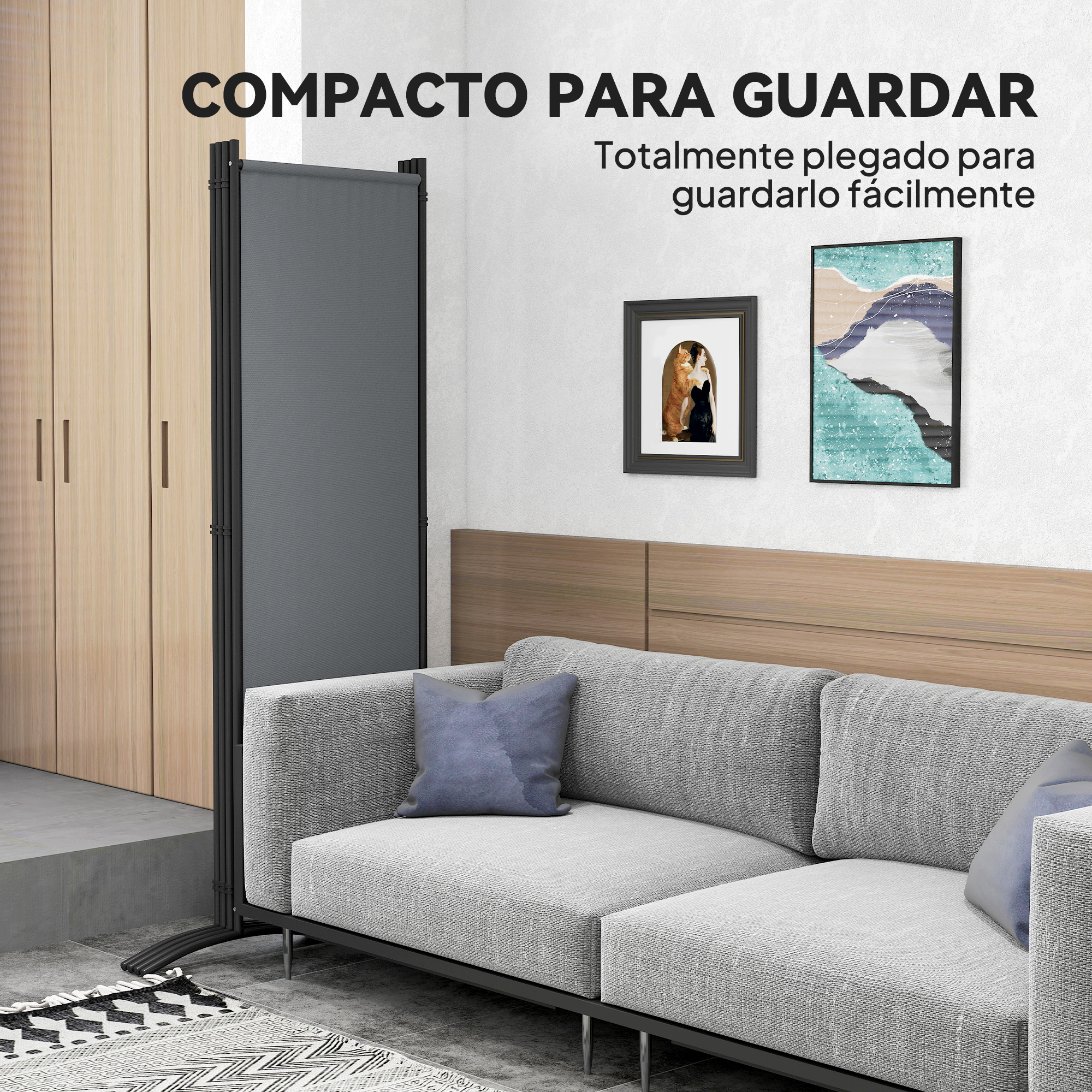 Un separador de ambientes gris junto a un sofá, con arte en la pared.