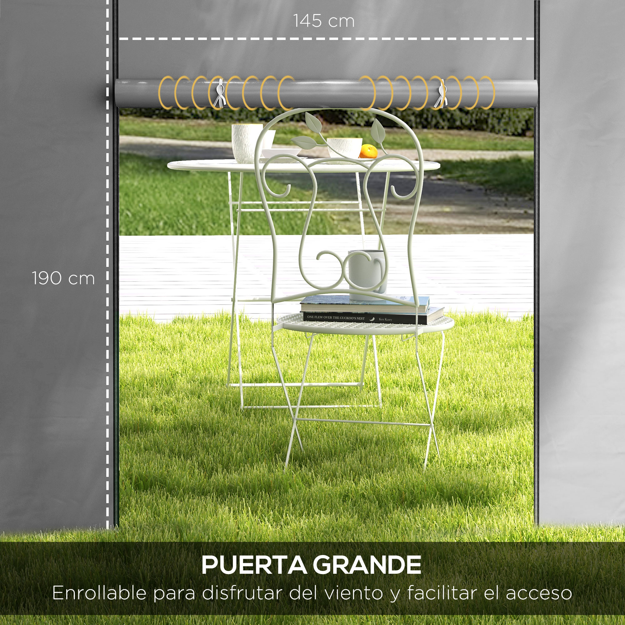 Mesa y silla blanca exterior con libros y taza sobre césped.