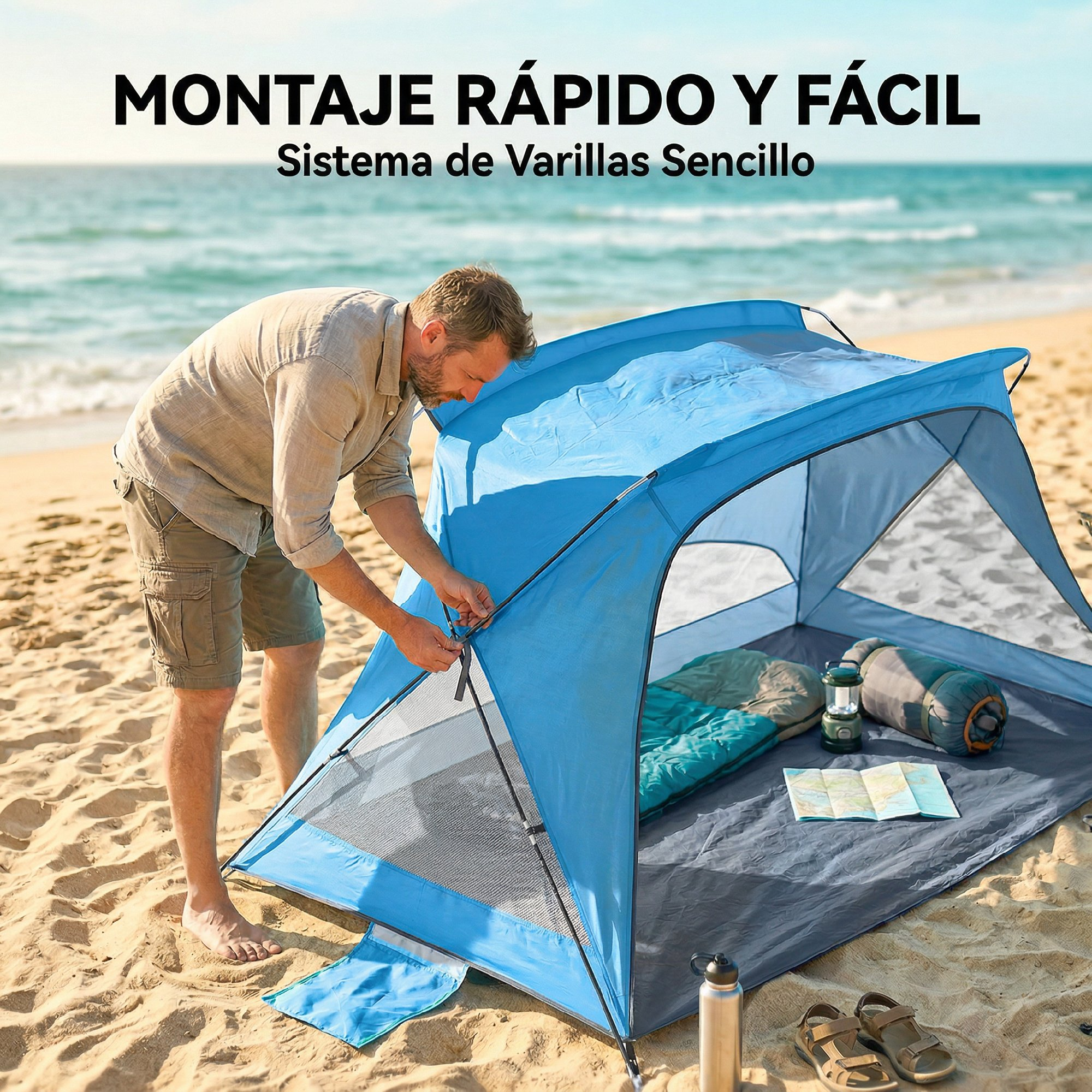 Hombre montando una carpa azul en la playa. Saco de dormir, linterna, mapa, botella de agua, sandalias.
