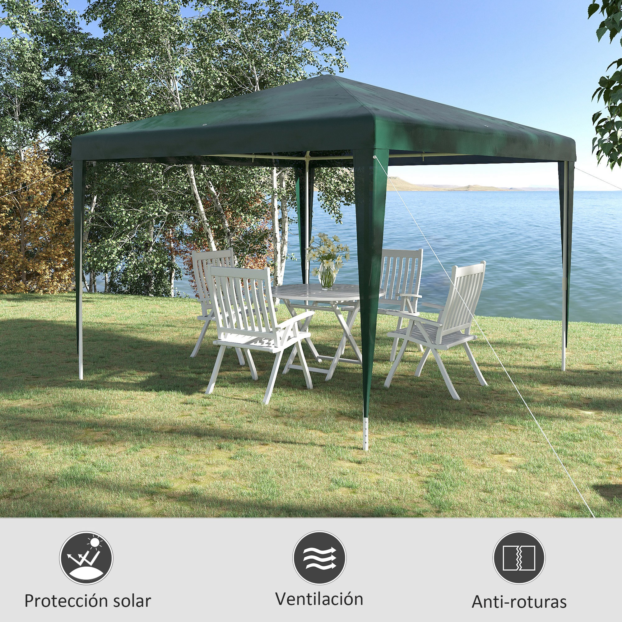 Gazebo verde oscuro con muebles de jardín blancos junto a un lago.