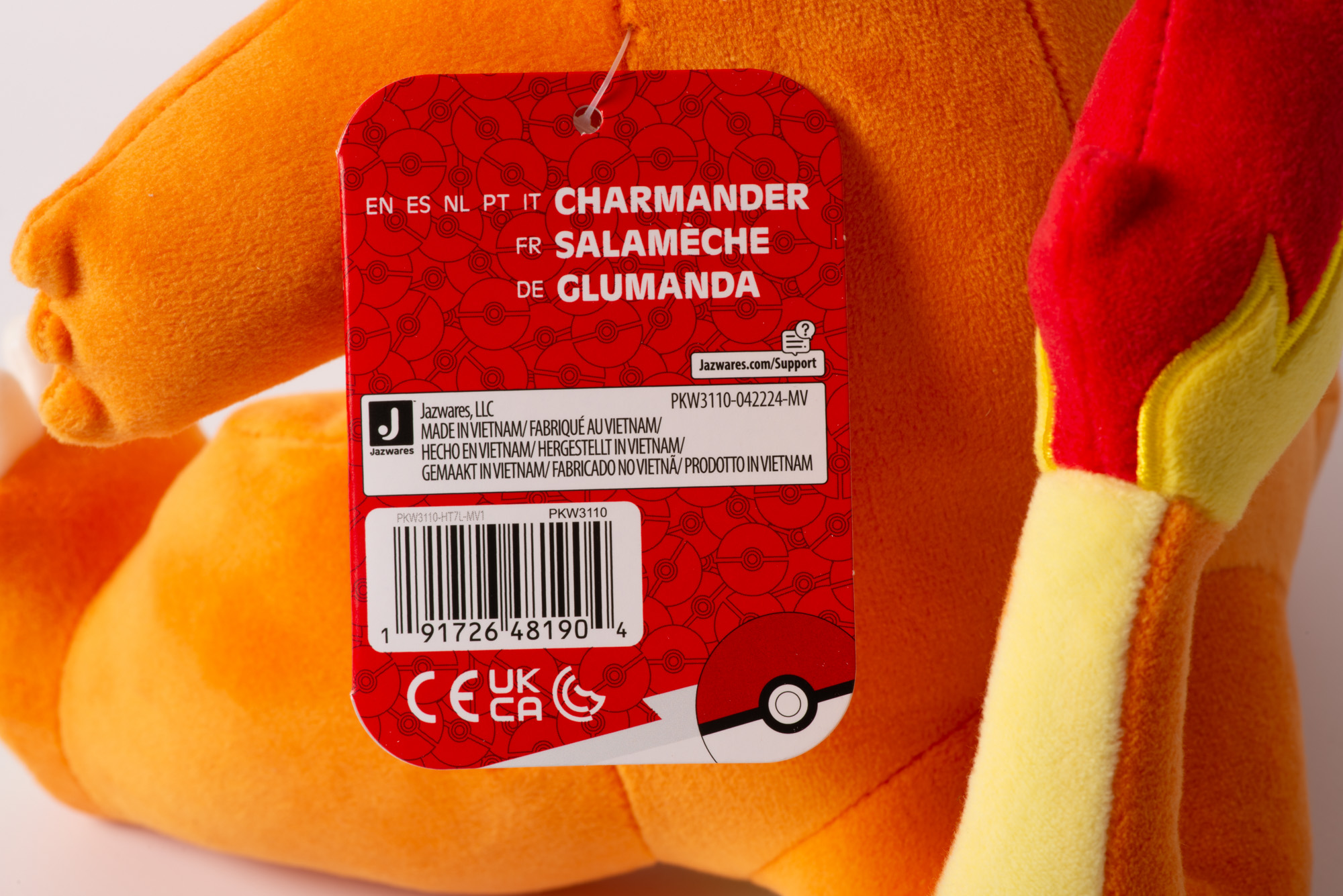 Ein orangefarbener Plüschcharakter mit einem roten Etikett. Hergestellt in Vietnam.