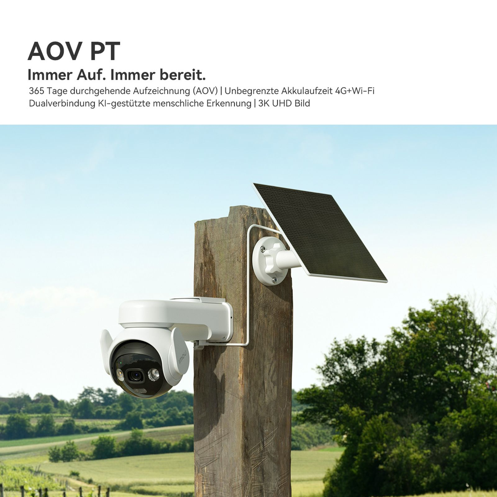 Biała kamera monitorująca z panelem słonecznym zamontowana na drewnianym słupku na zewnątrz.