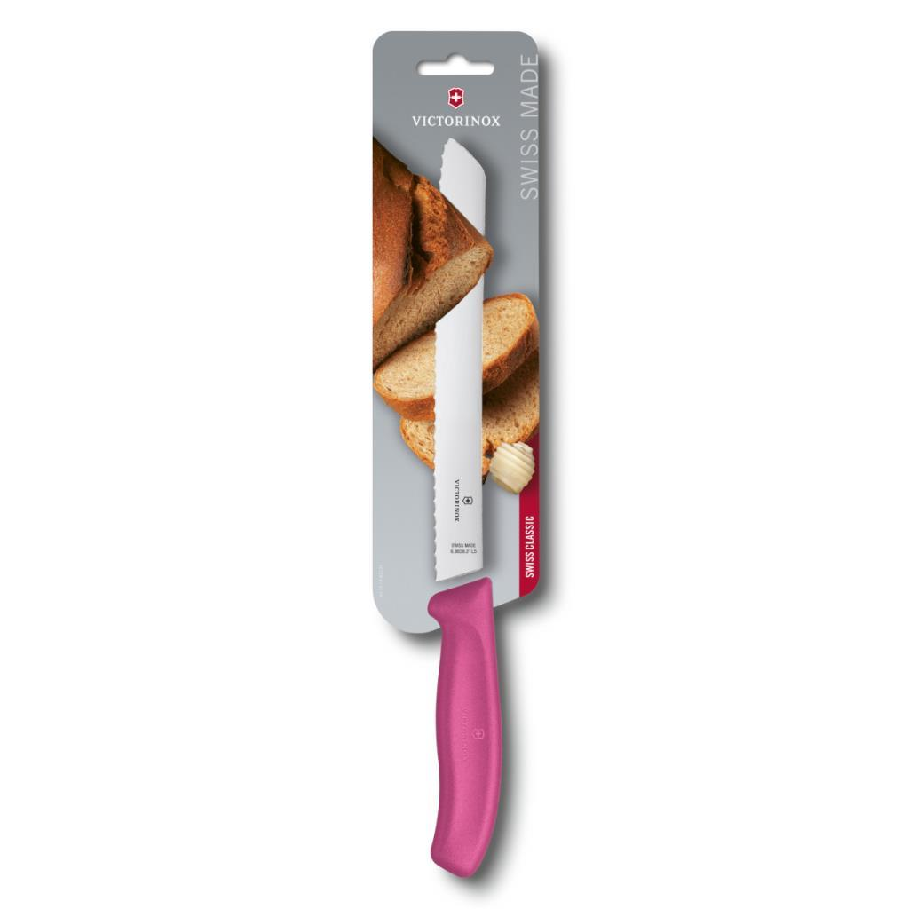 Dişli bıçaklı pembe Victorinox ekmek bıçağı ekmek dilimleri üzerinde duruyor.