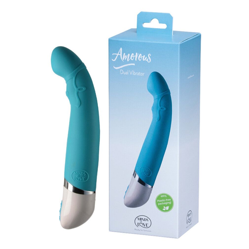 Ein tealfarbener Dual-Vibrator mit silberner und weißer Basis neben seiner tealfarbenen Verpackung.