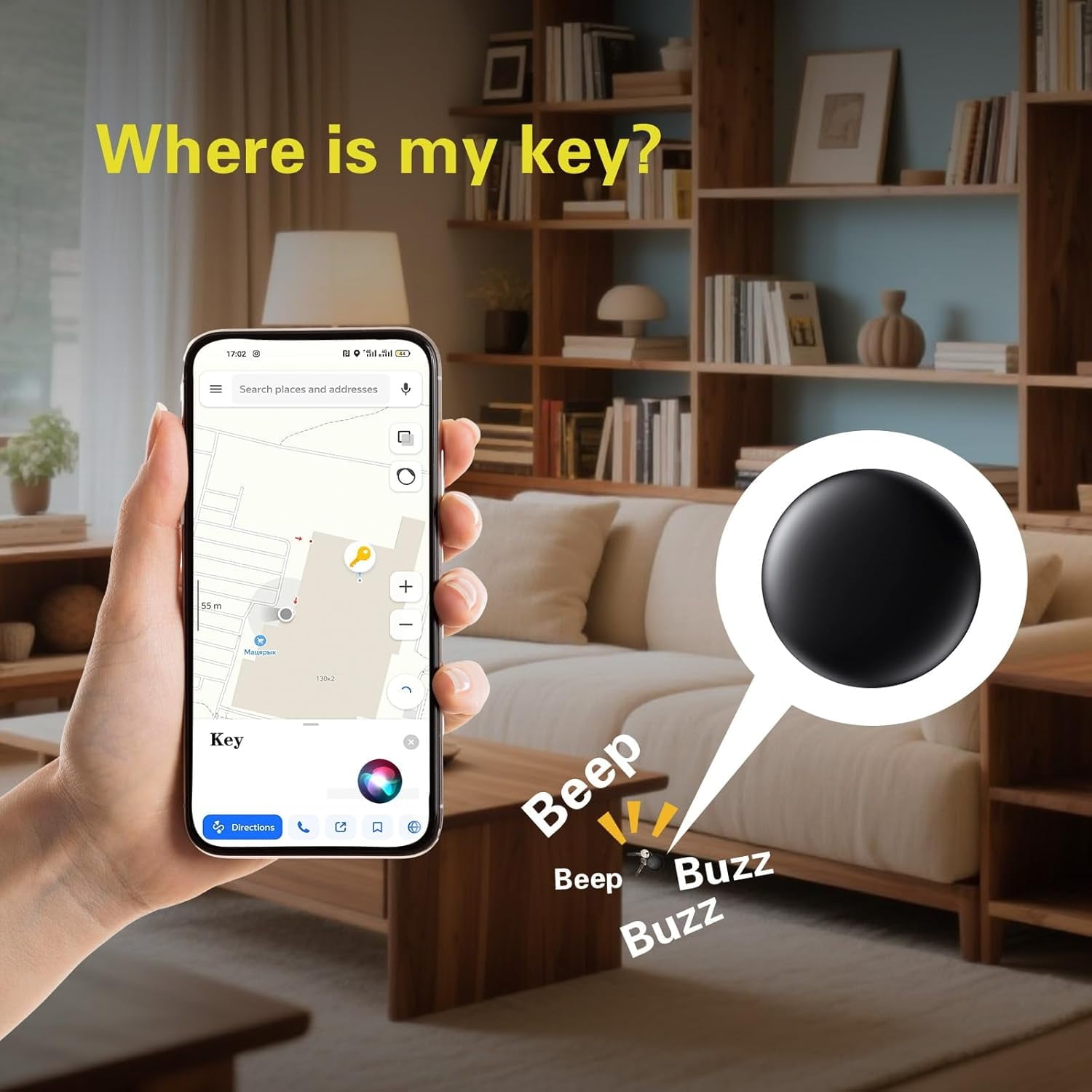 Hand hält Handy mit Karte, Schlüsselanhänger piept unter Sofa.
