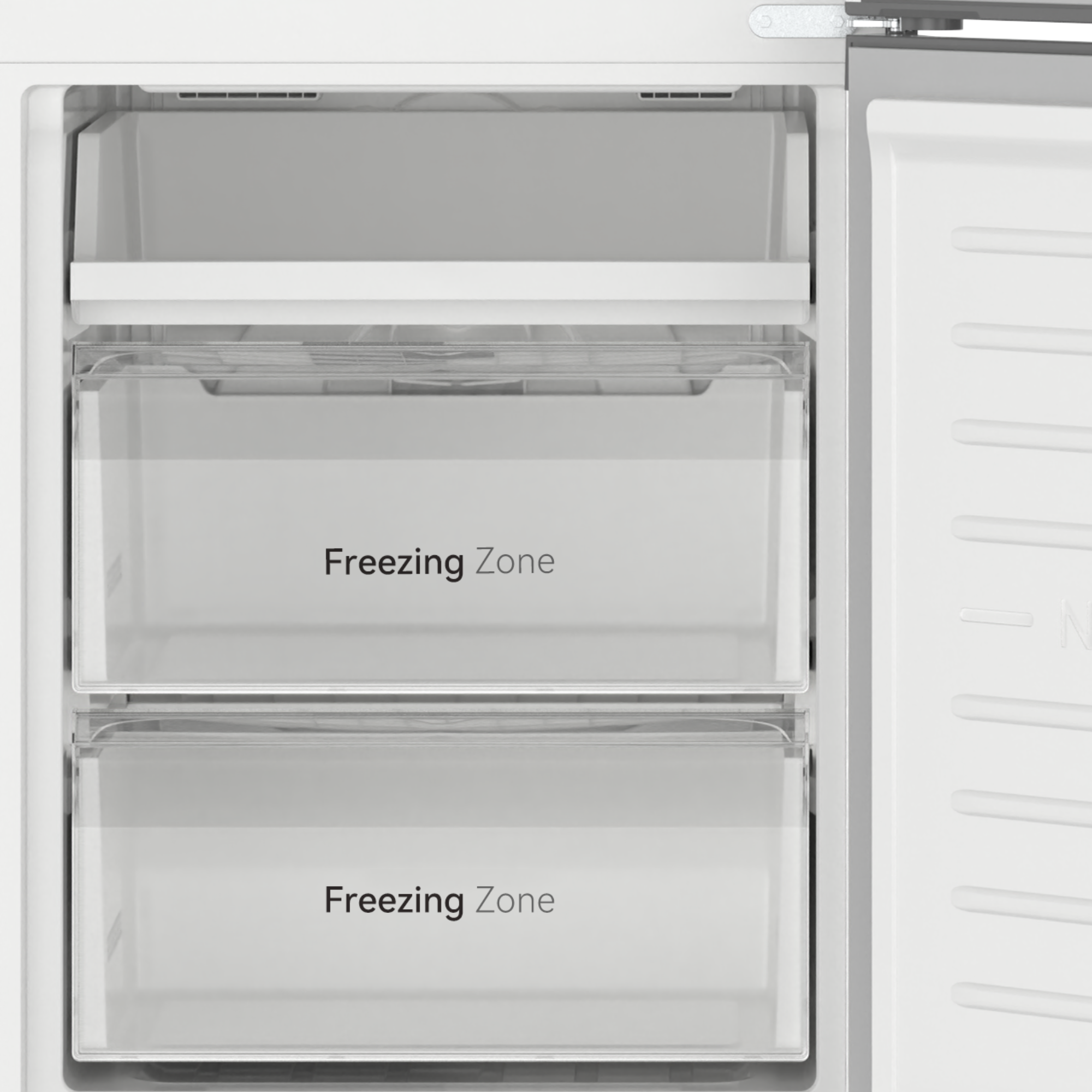 Interior de refrigerador con dos cajones congeladores transparentes, cada uno etiquetado 'Freezing Zone'.