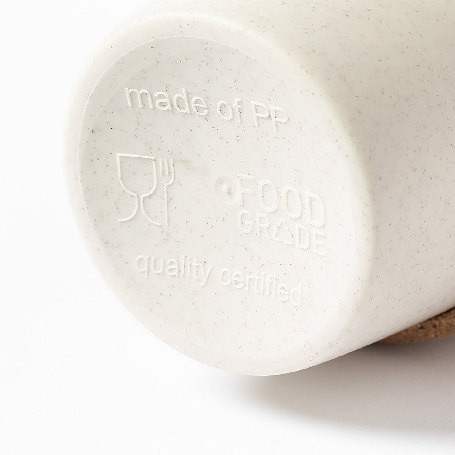 Primo piano del fondo di una tazza beige con testo in rilievo: 'made of PP', 'FOOD GRADE', 'quality certified'.