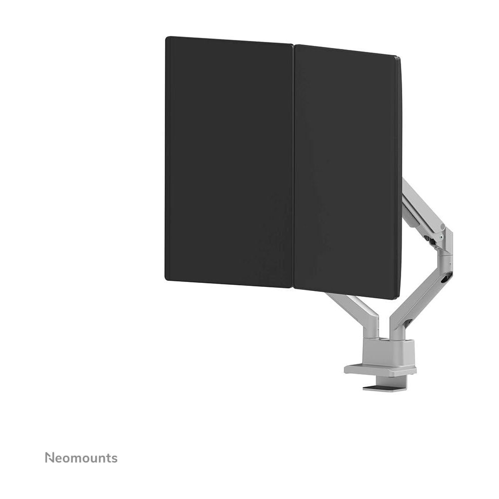 Two black monitors on a silver arm clamped to a desk.