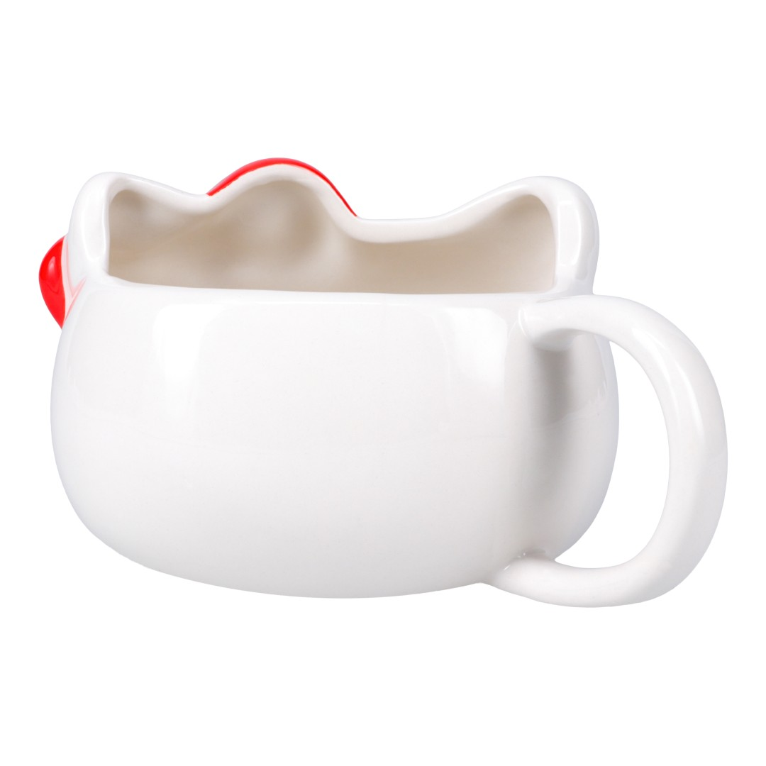 Biały ceramiczny kubek w kształcie głowy Hello Kitty z czerwonymi akcentami.