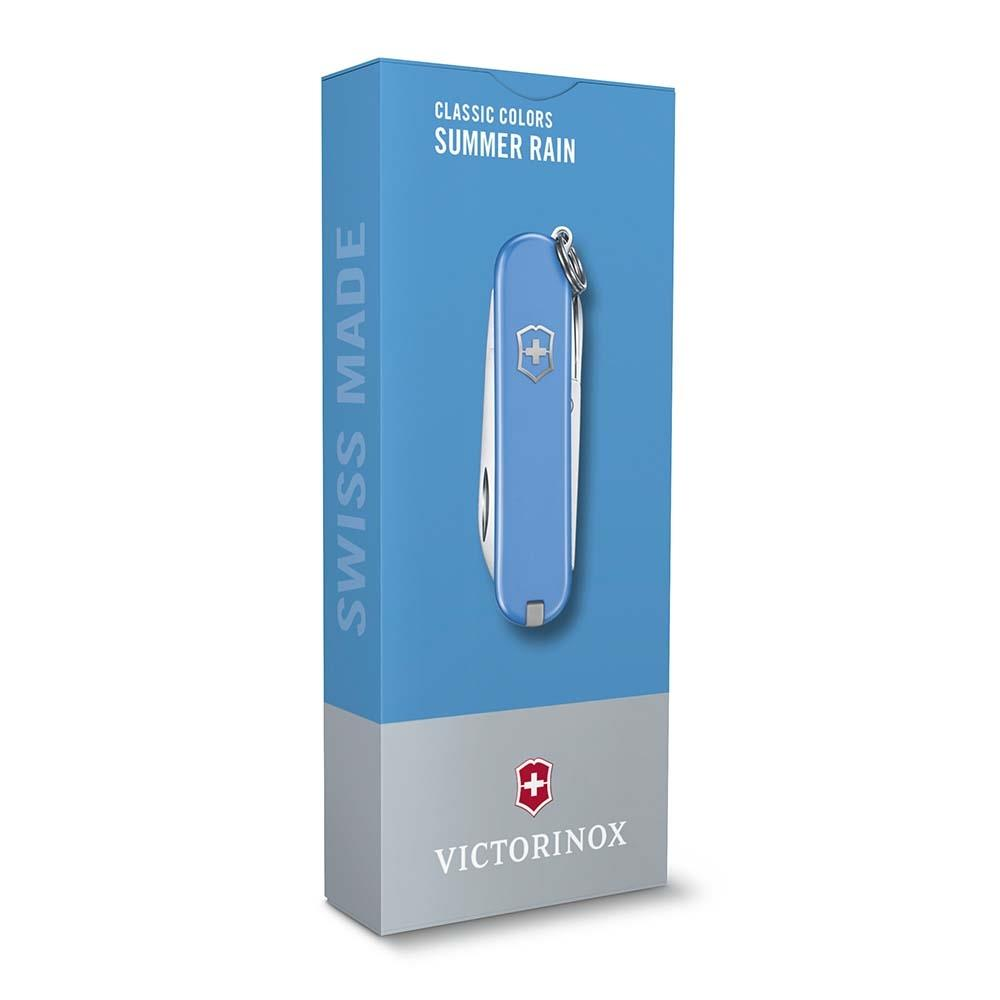 Gümüşi İsviçre çakısı ve "Swiss Made" yazılı mavi Victorinox kutusu.
