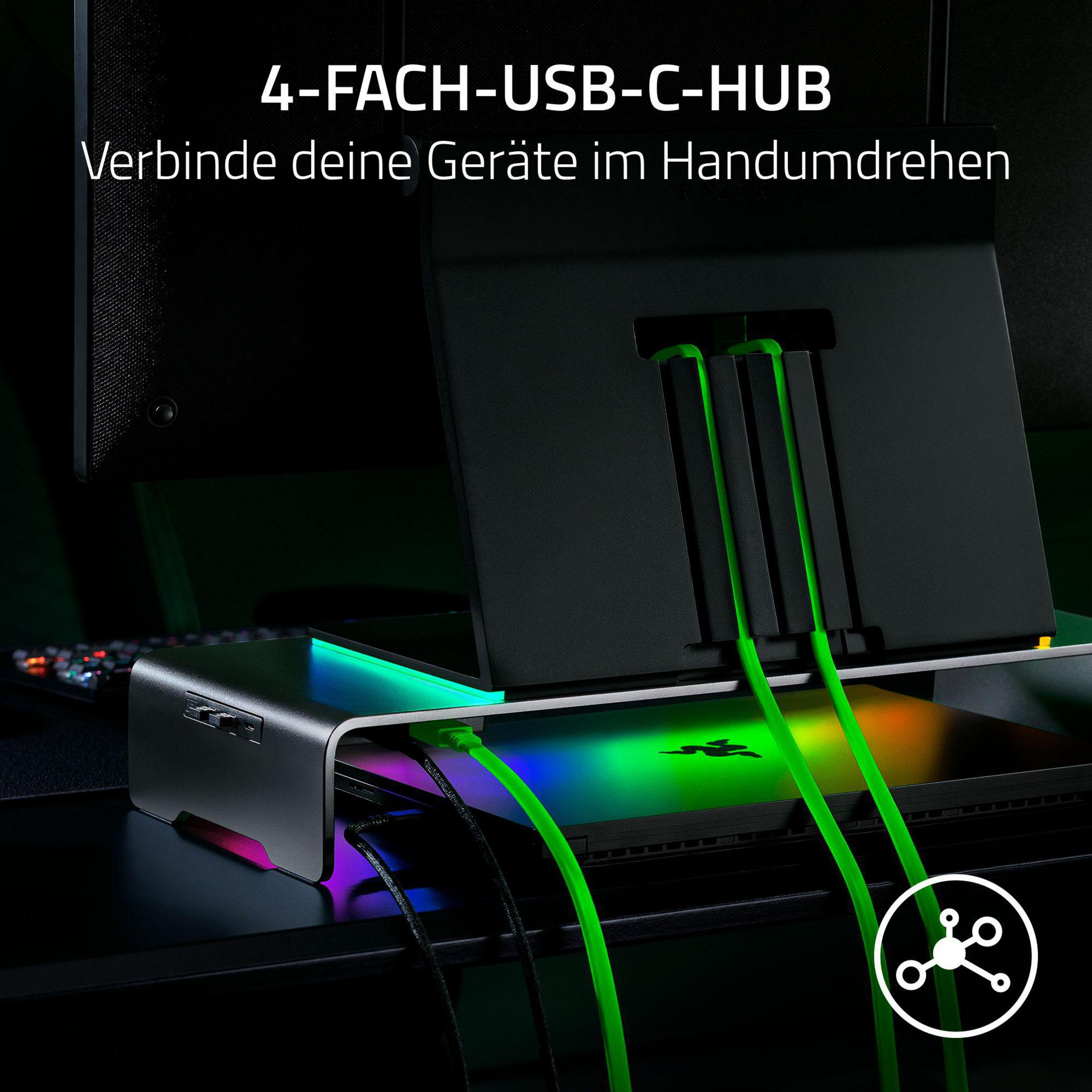 Ein silberner USB-C-Hub mit RGB-Beleuchtung und grünen Kabeln.