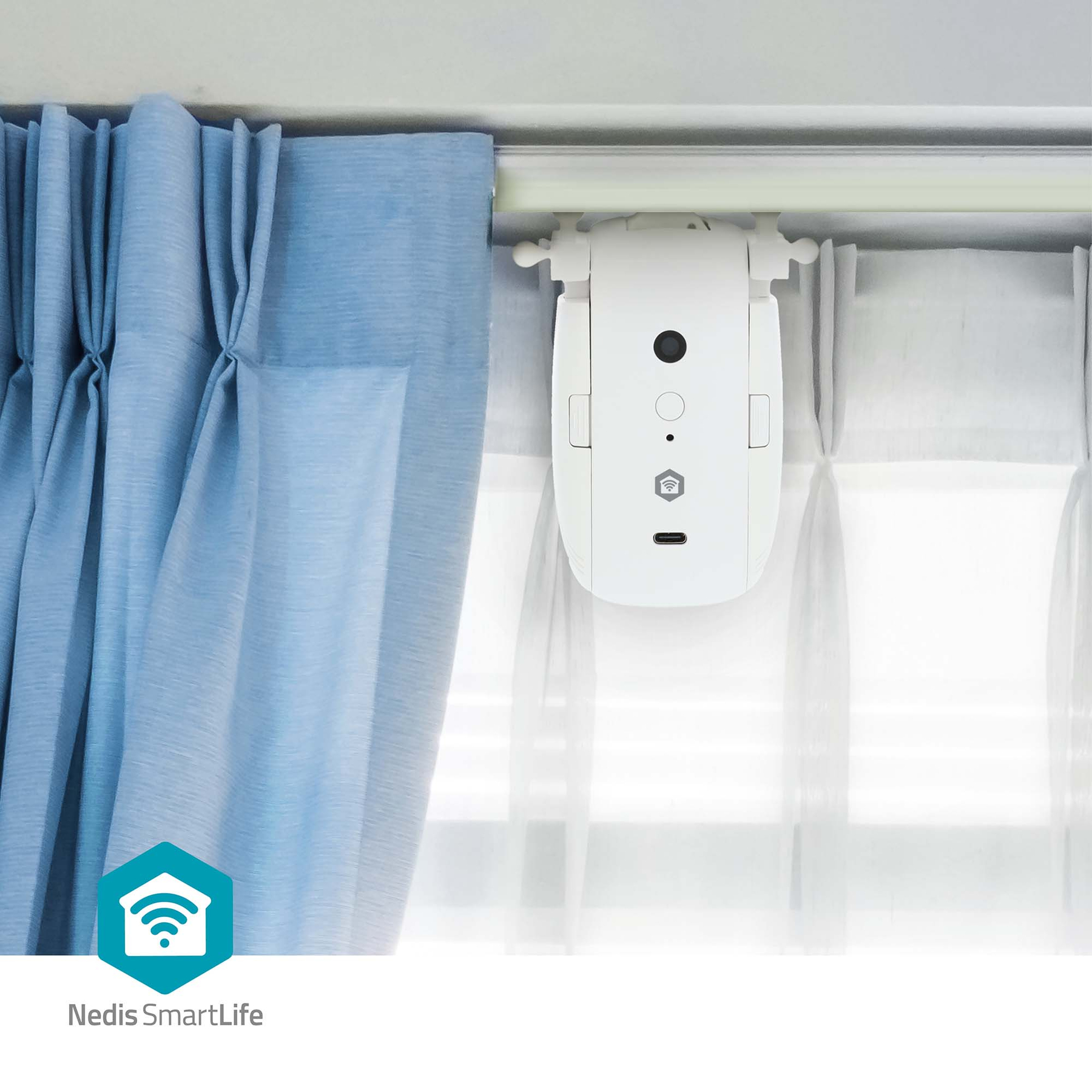 Un robot per tende bianco è fissato a un bastone per tende accanto a tende blu e bianche.