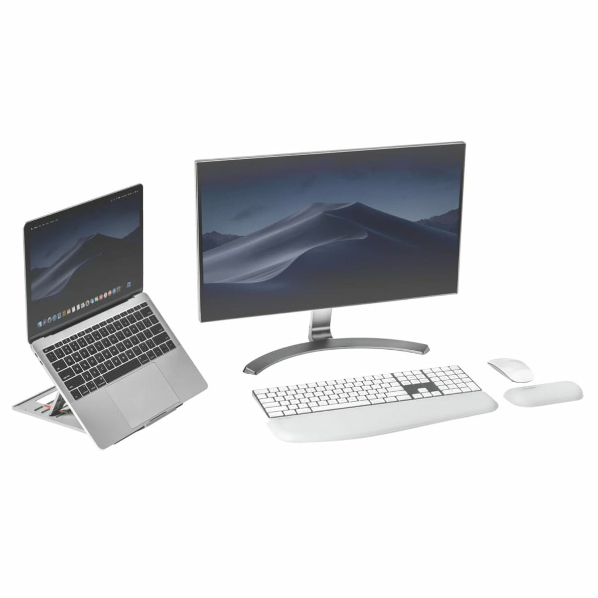 A silver laptop on a stand, a monitor, a keyboard, and a mouse.