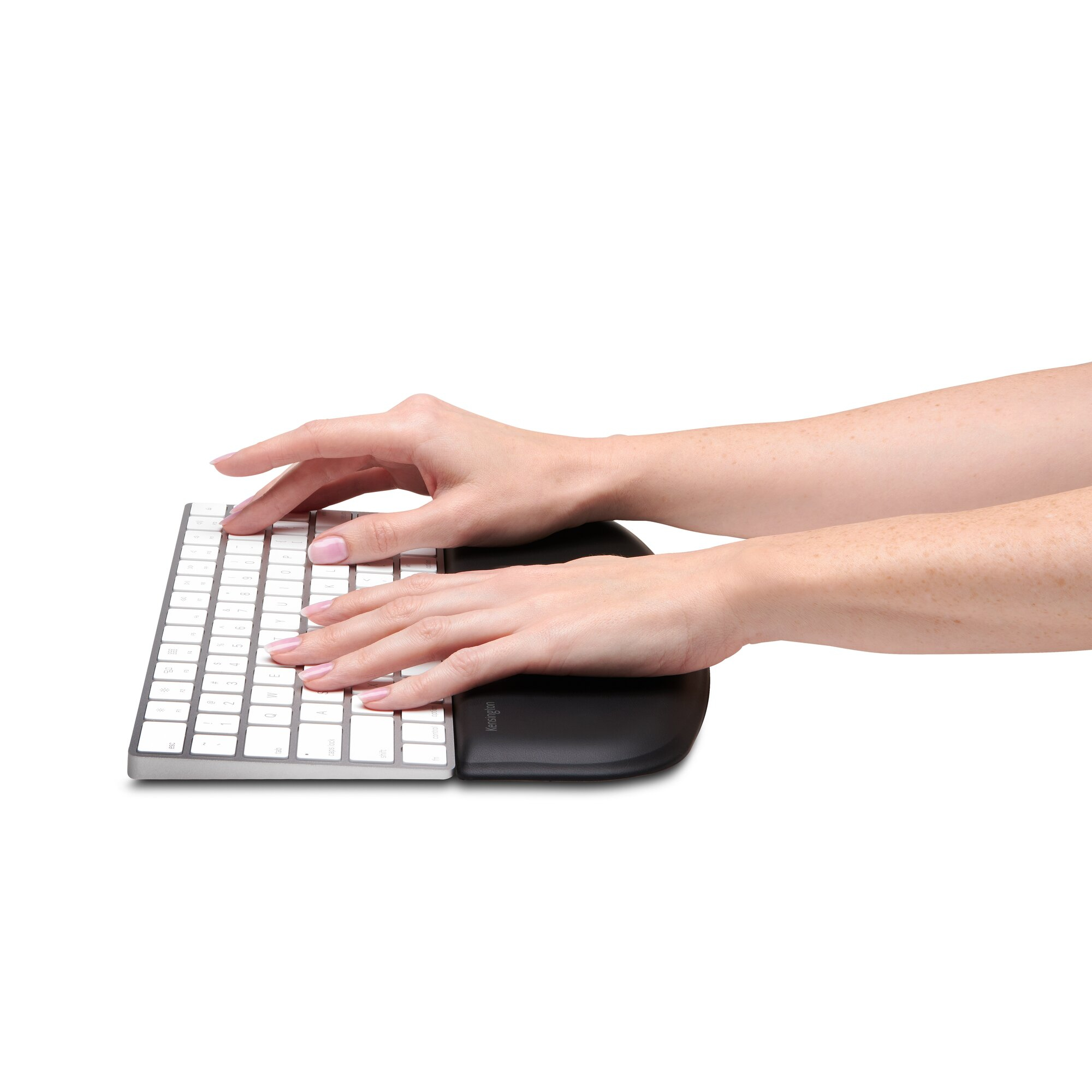 Hands typing on a keyboard with a wrist rest.