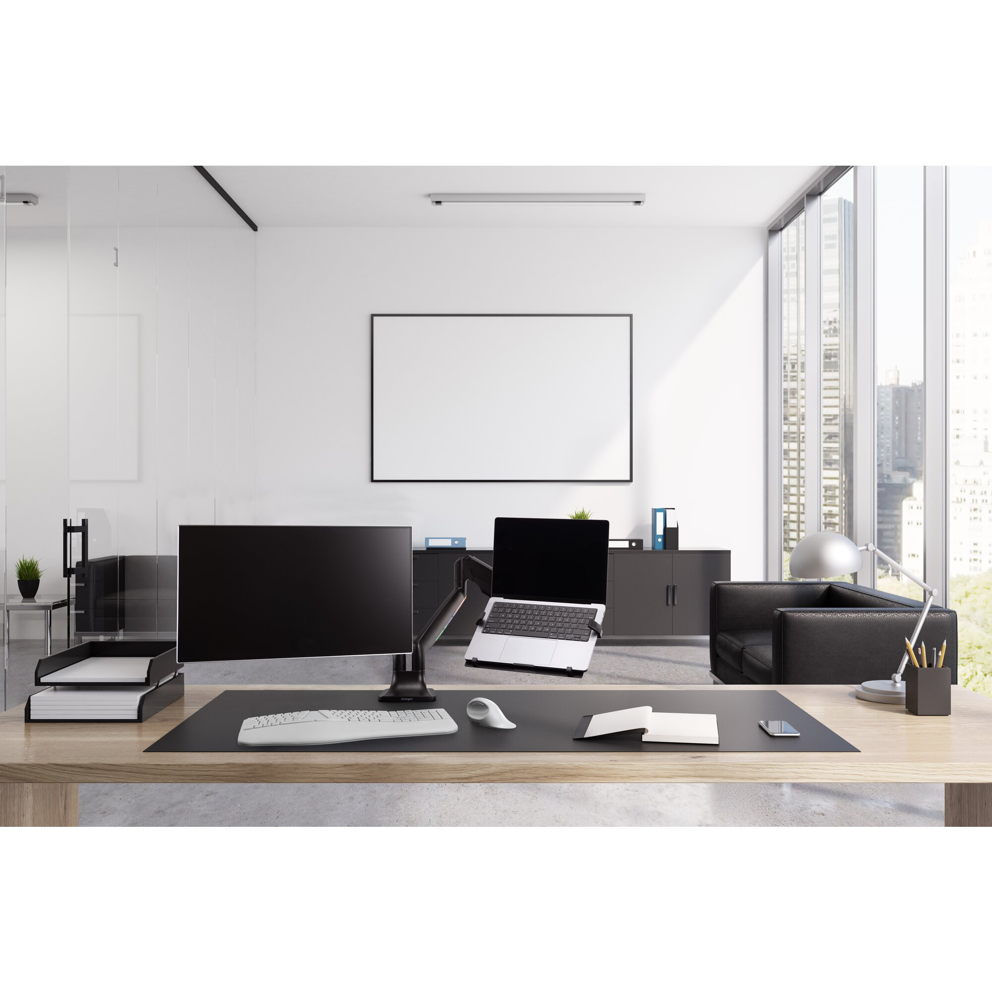 Modern office desk with computer monitor, laptop, keyboard, and mouse.