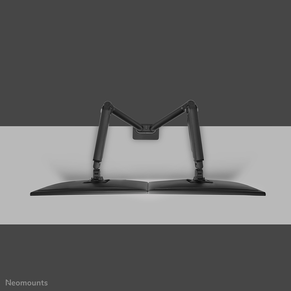 A black dual monitor arm with two monitors, mounted on a gray wall.